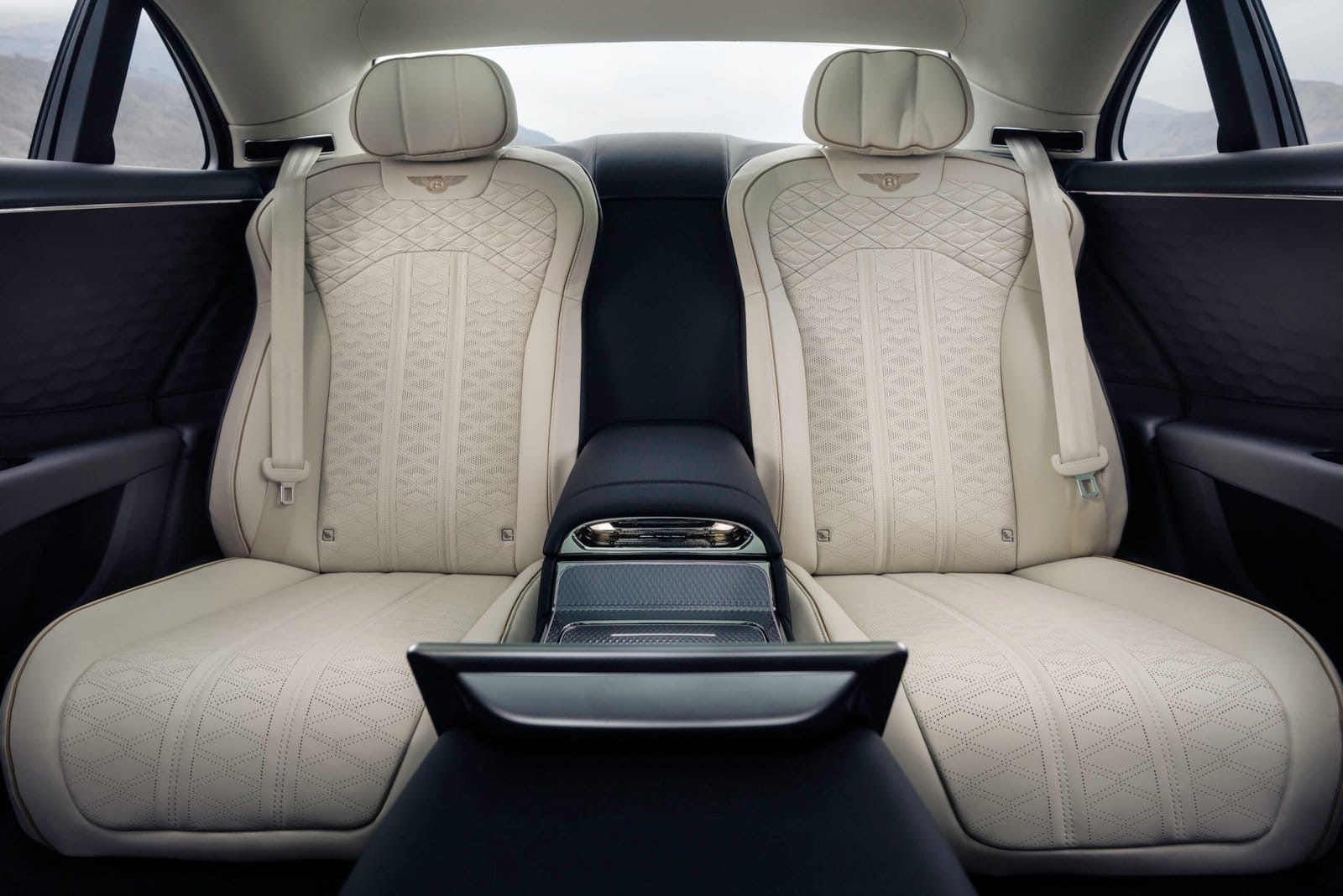 Diamond-stitched white leather rear seats inside the Bentley Flying Spur Plug-in Hybrid electric vehicle Mulliner edition