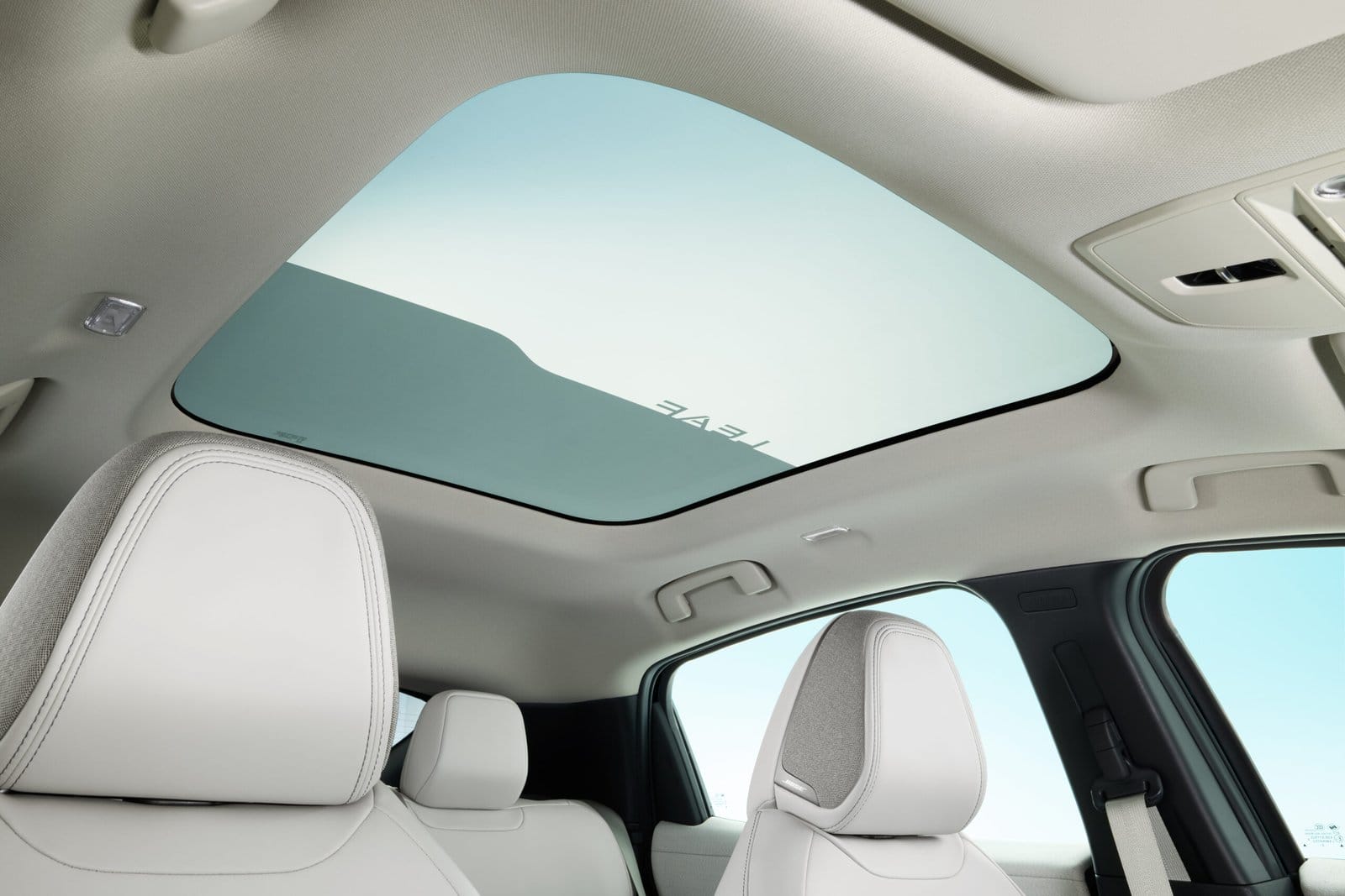 Nissan Leaf electric vehicle interior showing the panoramic glass roof and front seat headrests