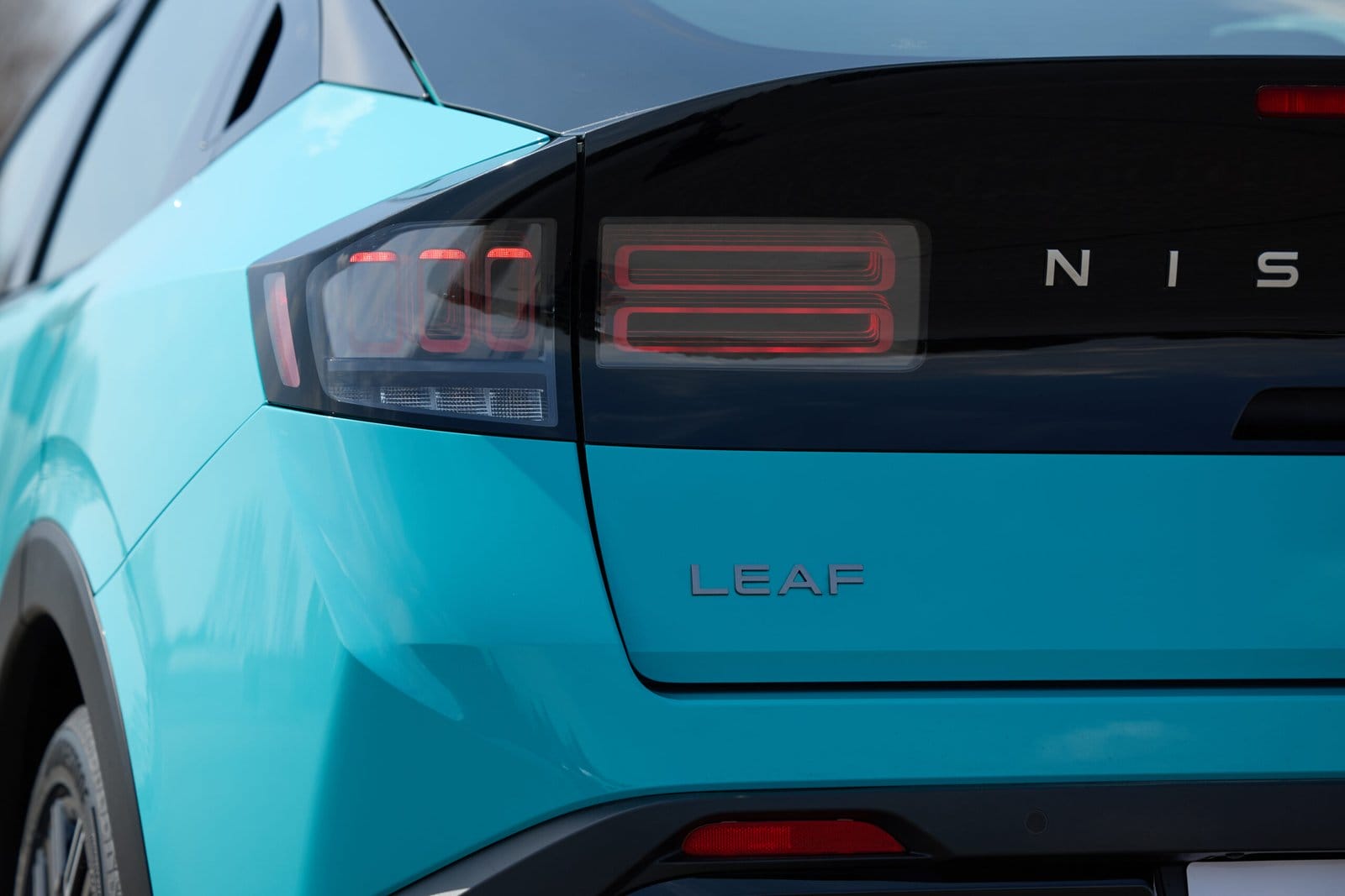 Close-up of the Nissan Leaf electric vehicle’s left taillight and LEAF badge on the rear hatch