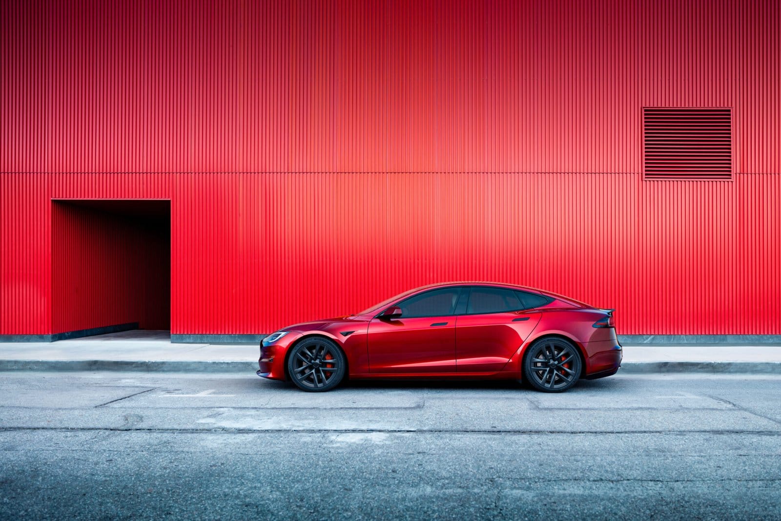 tesla model s electric vehicle red wall