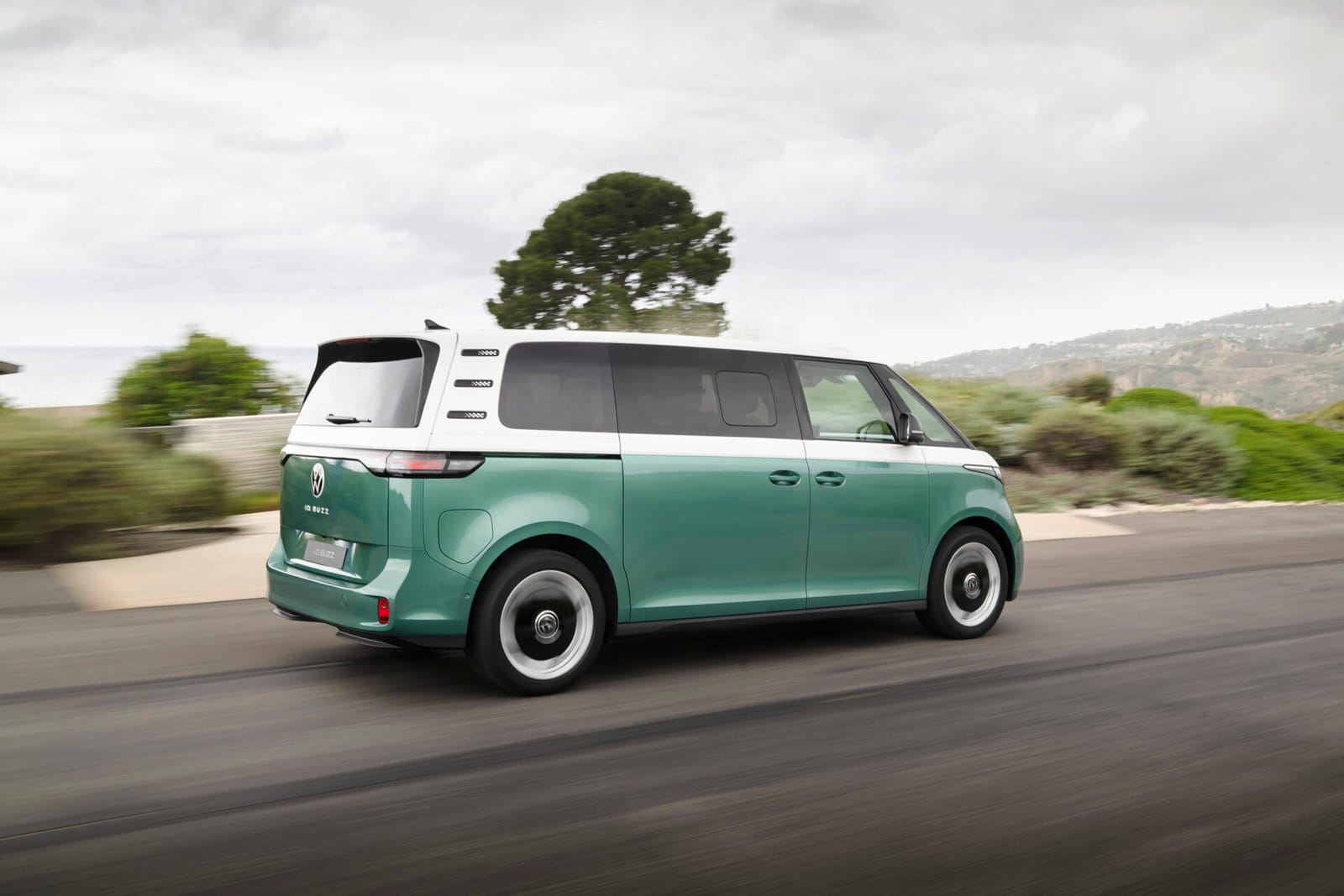volkswagen id buzz electric vehicle green rear driving