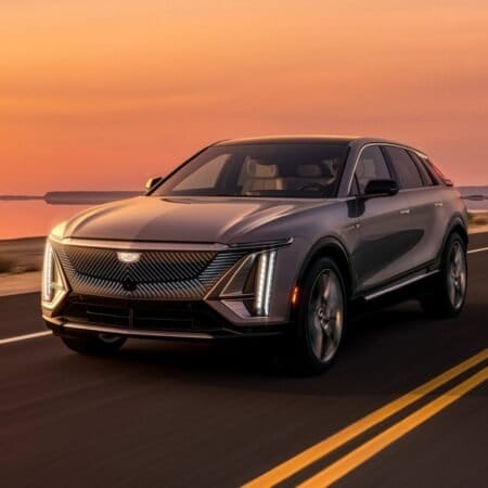 Cadillac Lyriq Electric Vehicle Driving on a Desert Road at Sunset 1