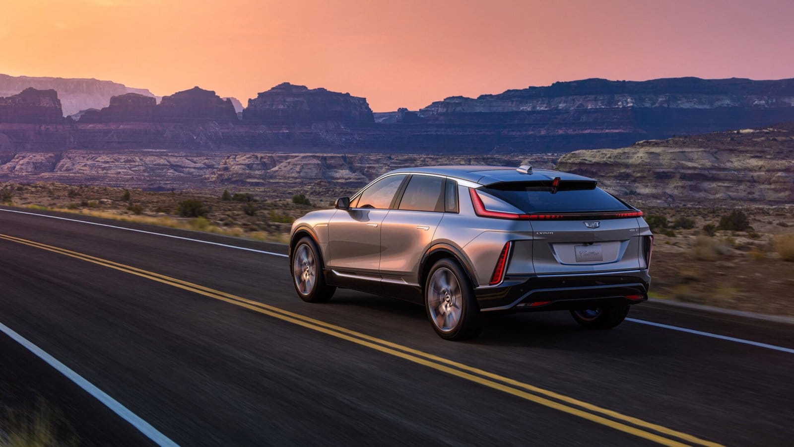 cadillac lyriq electric vehicle desert highway mountains