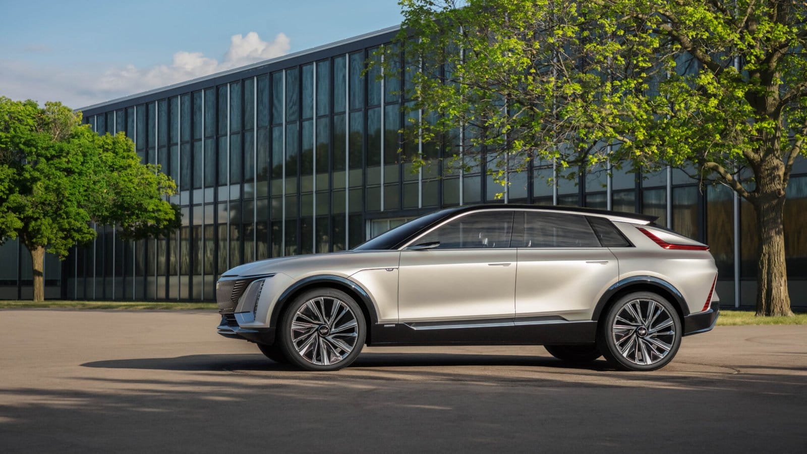 cadillac lyriq electric vehicle glass building trees