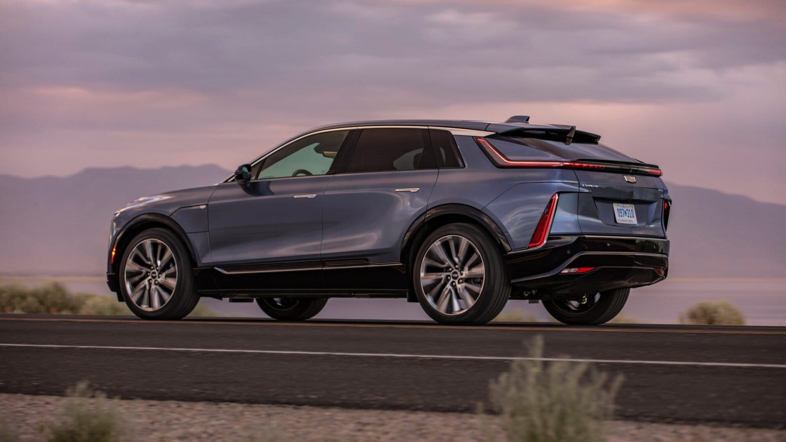 cadillac lyriq electric vehicle mountain road scenery