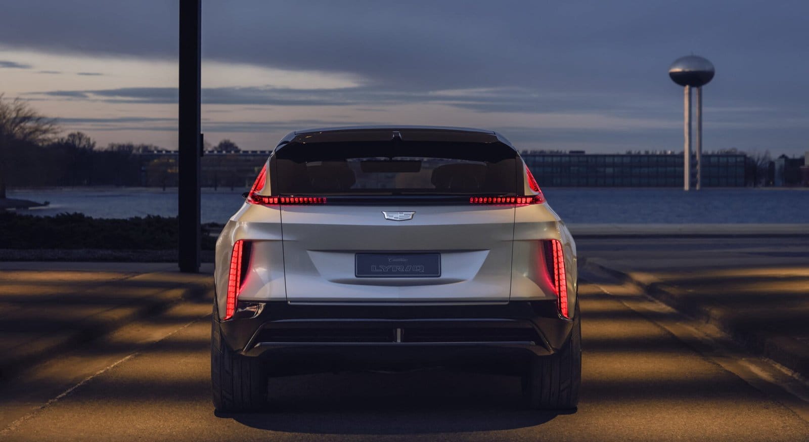 cadillac lyriq electric vehicle rear view evening lake