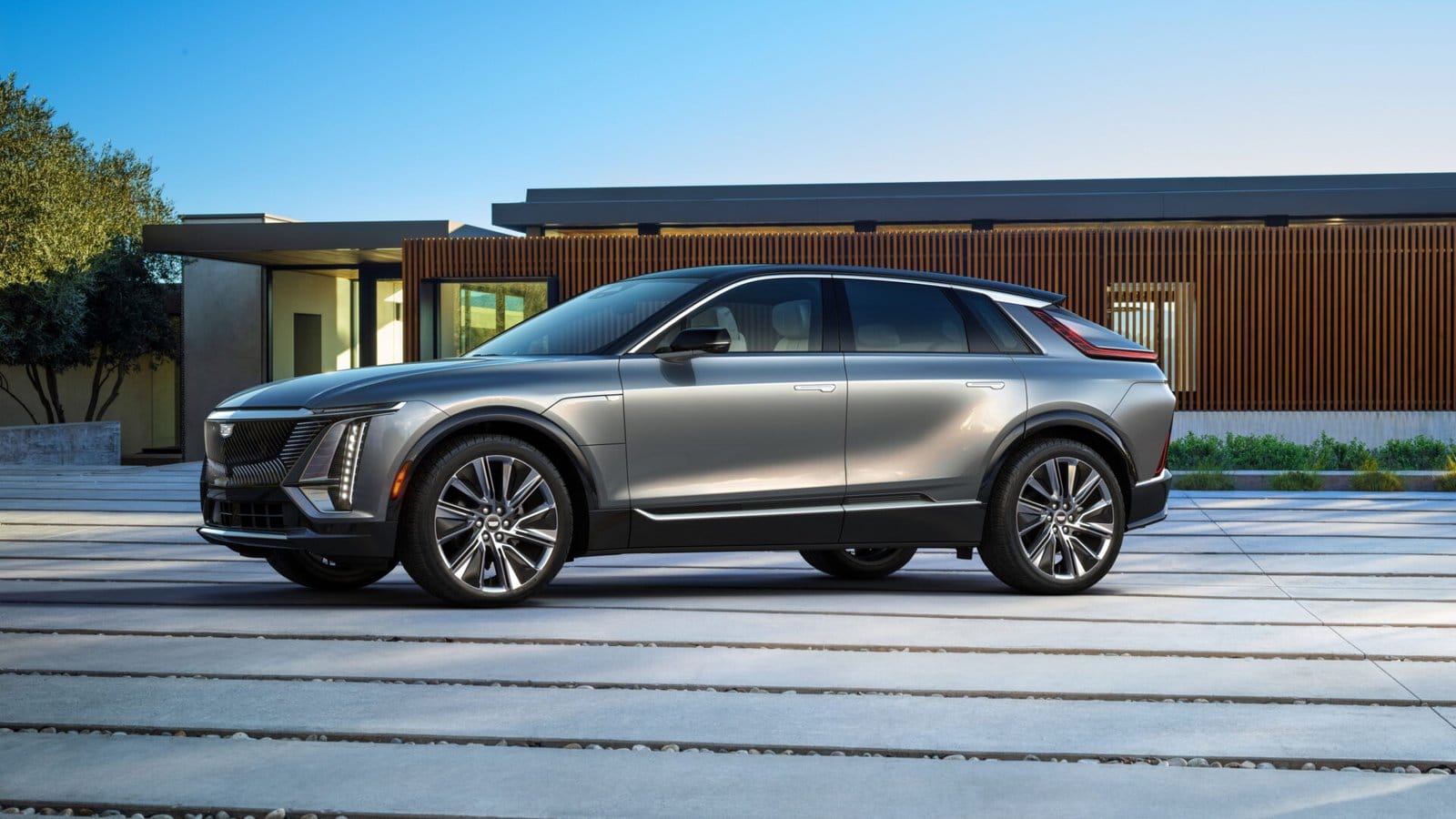 cadillac lyriq electric vehicle side view modern home