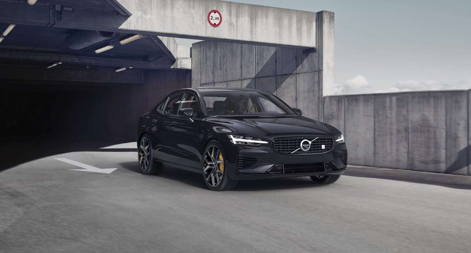 volvo s60 recharge electric vehicle exiting parking garage