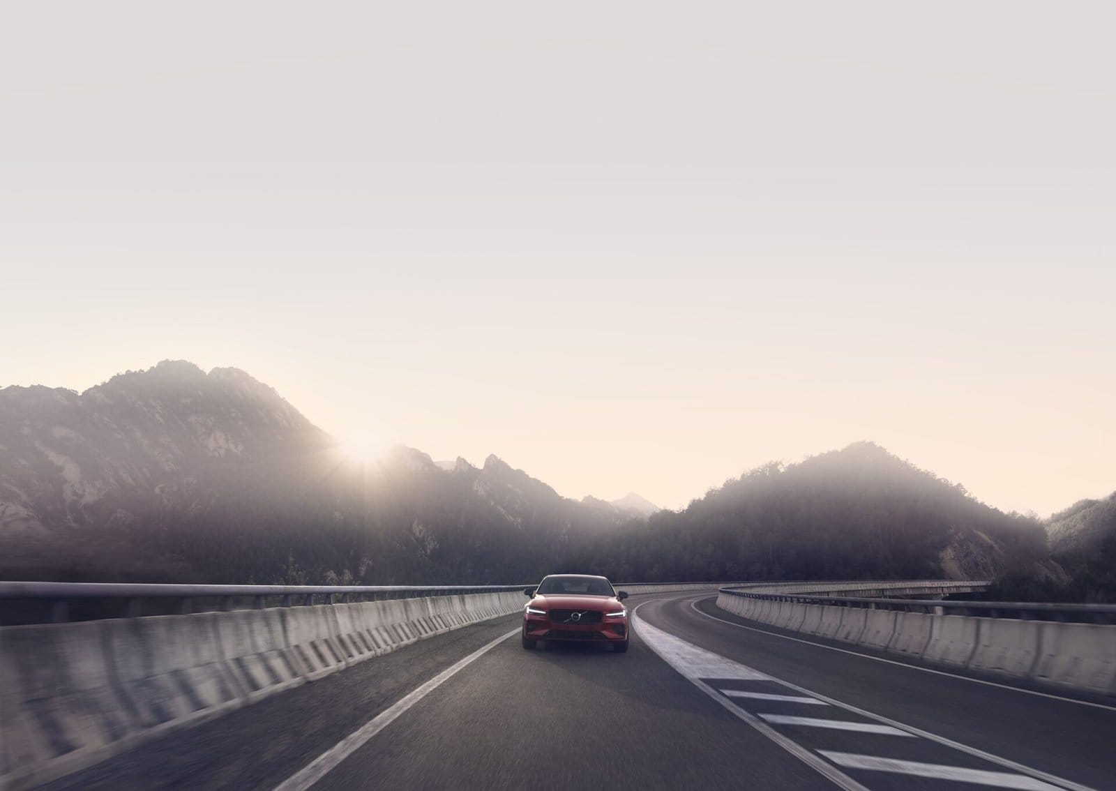 volvo s60 recharge electric vehicle mountain road sunrise