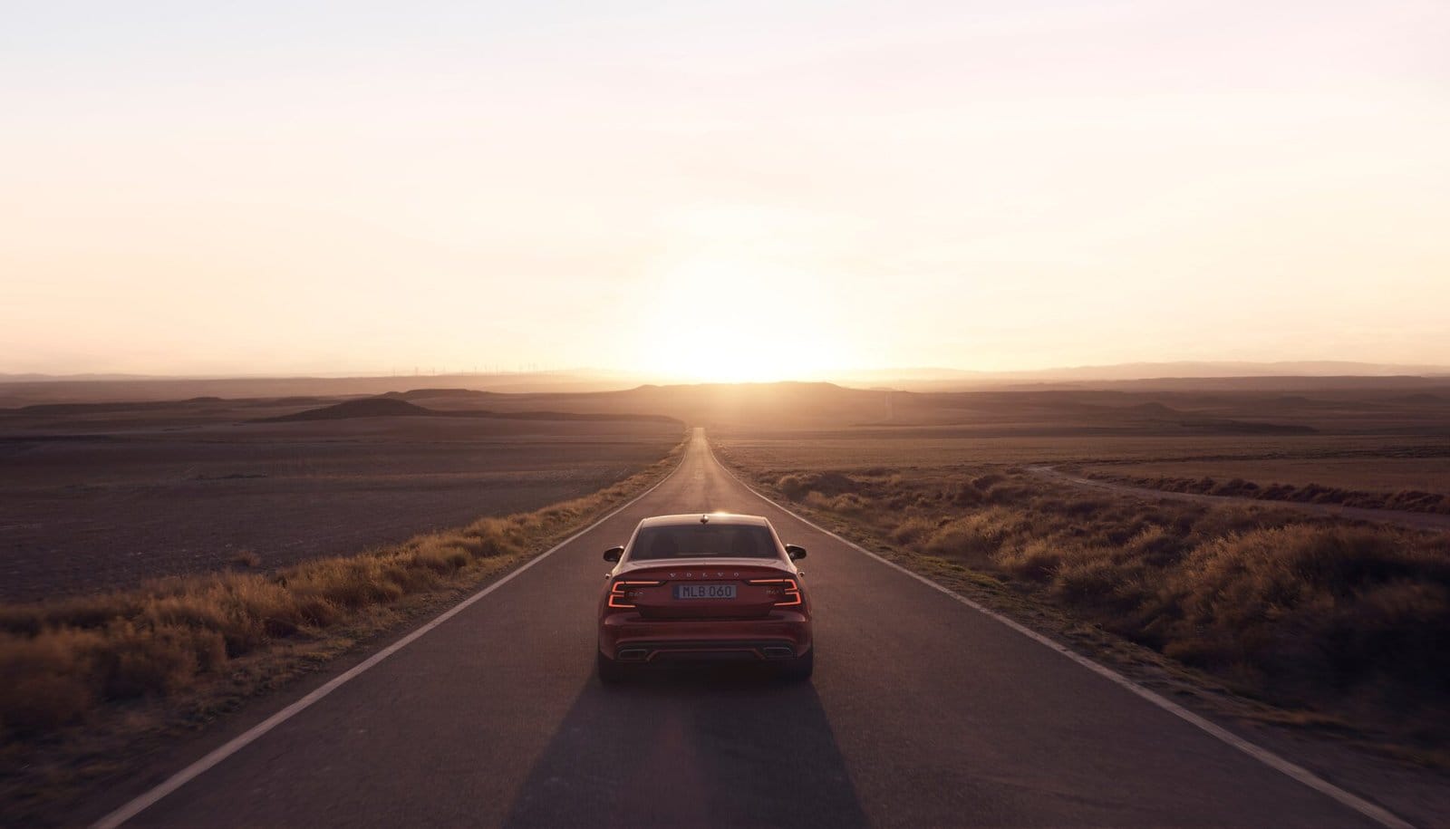 volvo s60 recharge electric vehicle open road sunset