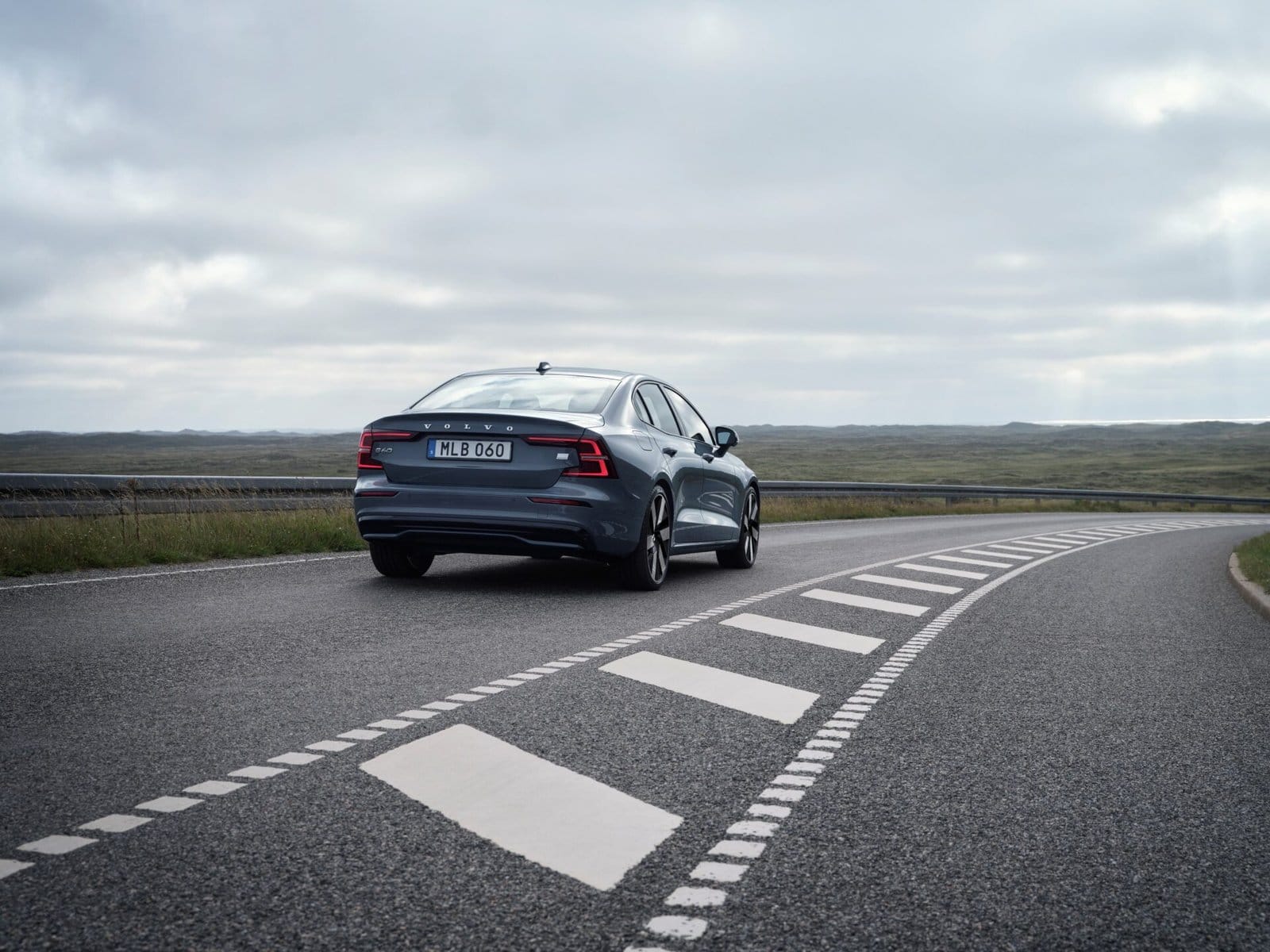 volvo s60 recharge electric vehicle rear view curved road