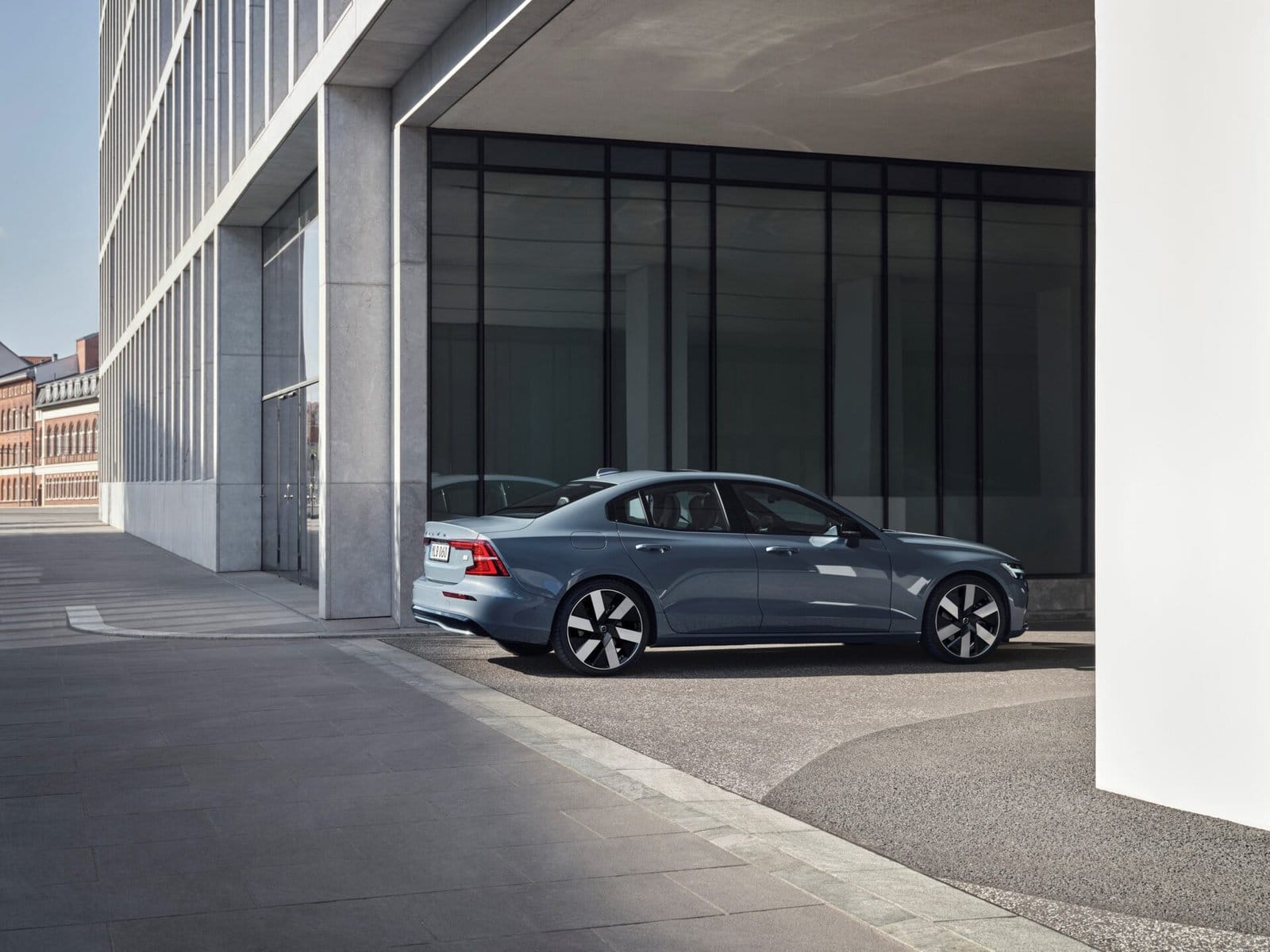 volvo s60 recharge electric vehicle urban setting modern architecture