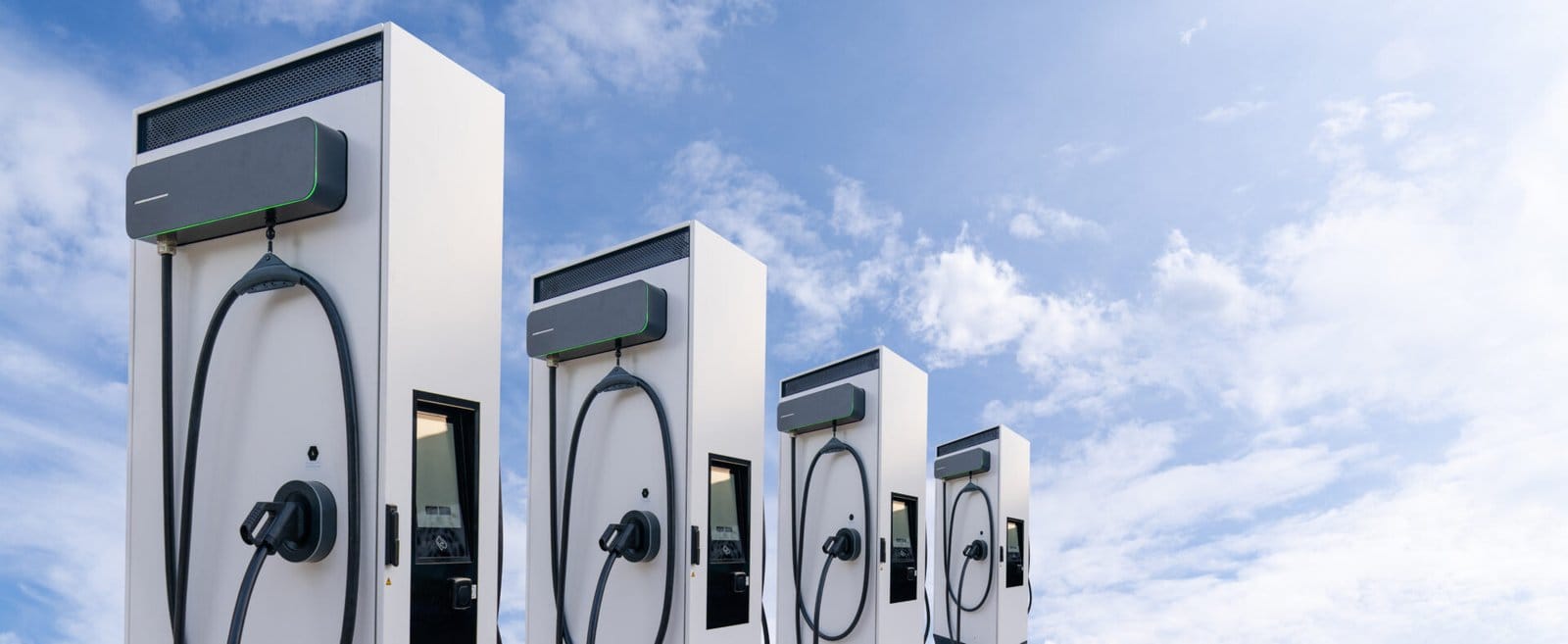 Row of electric vehicles charging stations on the background of blue sky
