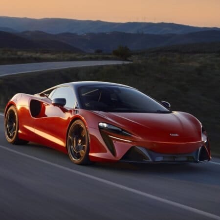 mclaren artura electric vehicle sunset mountain road
