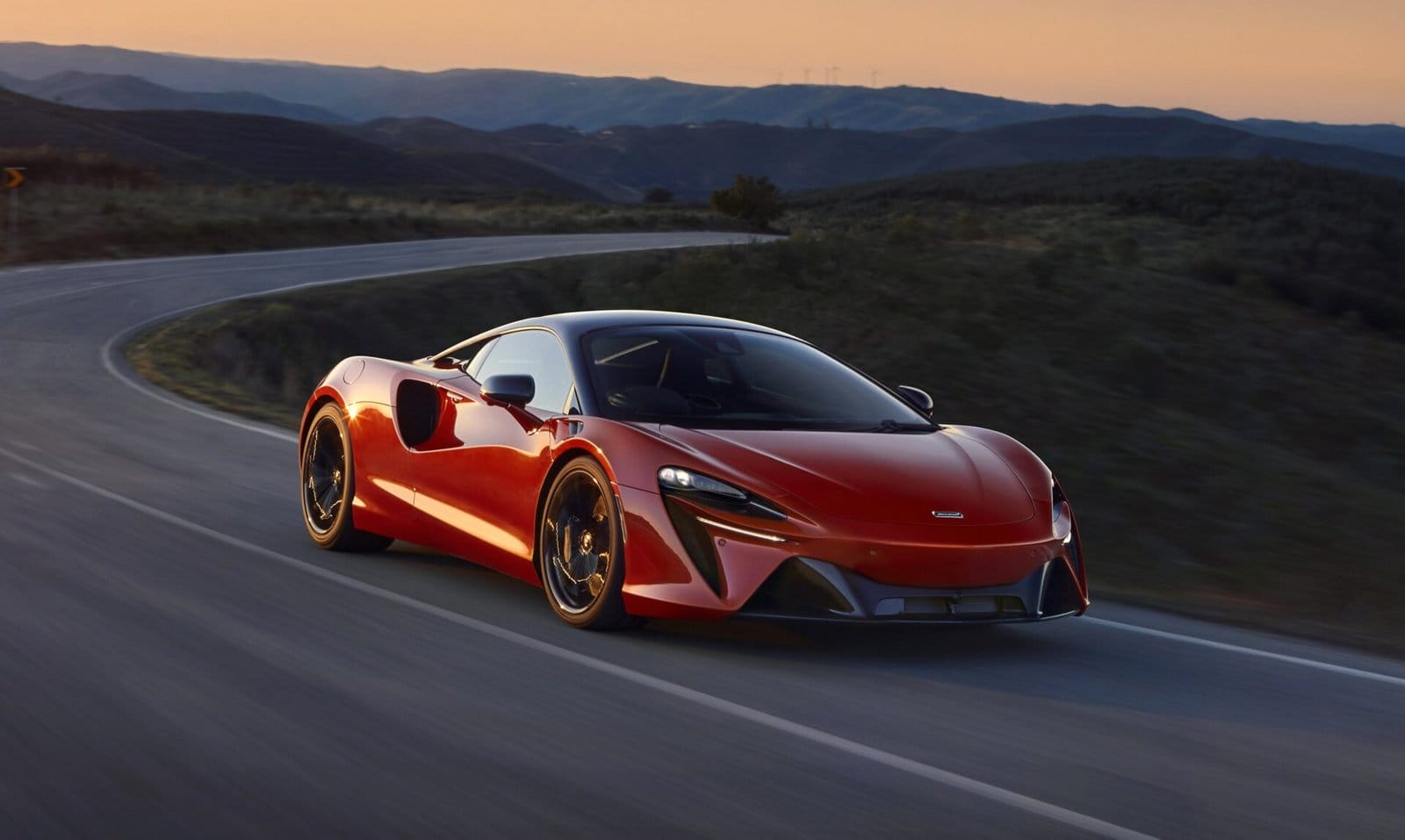 mclaren artura electric vehicle sunset mountain road