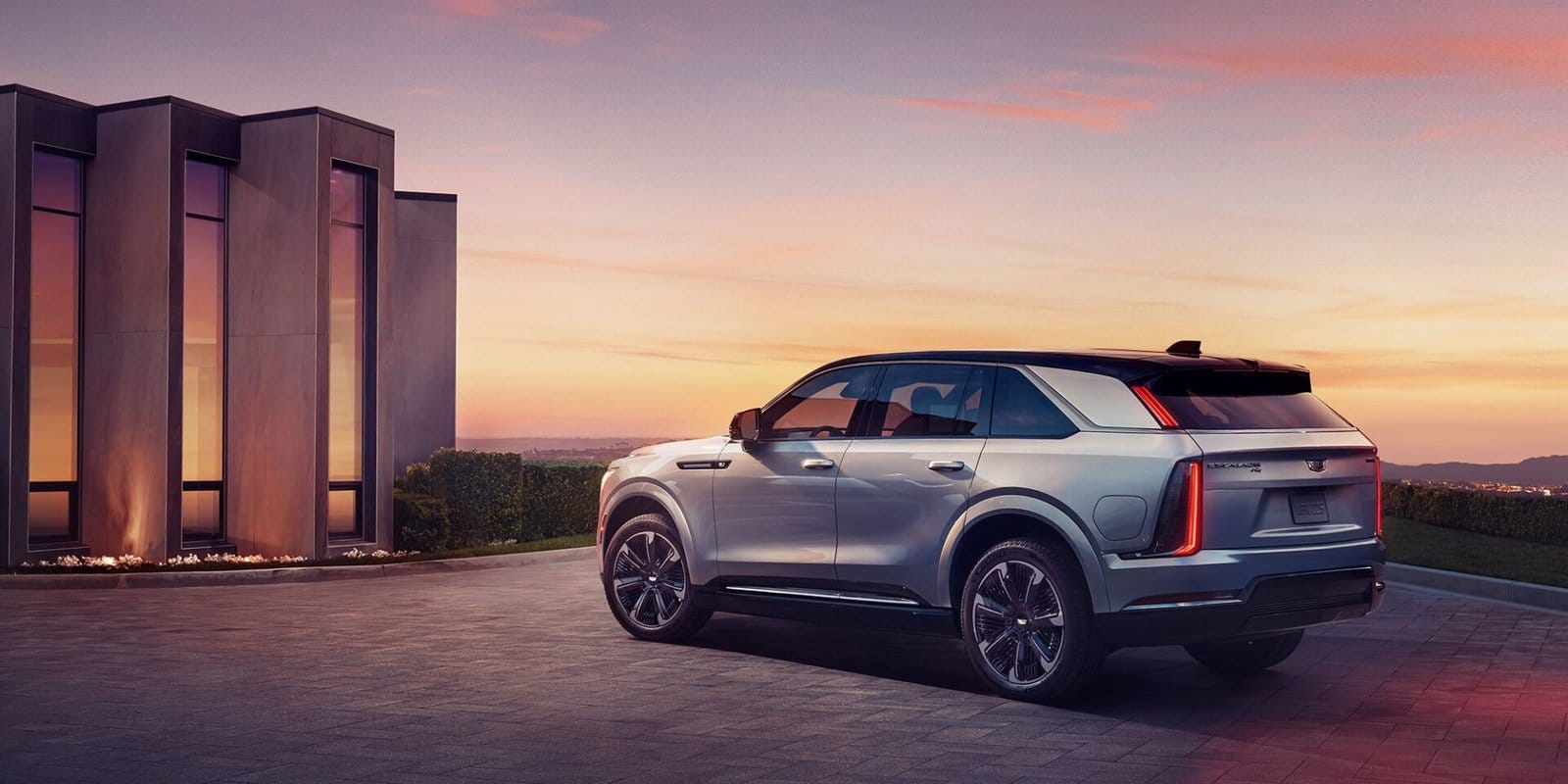 cadillac escalade iq electric suv modern architecture sunset
