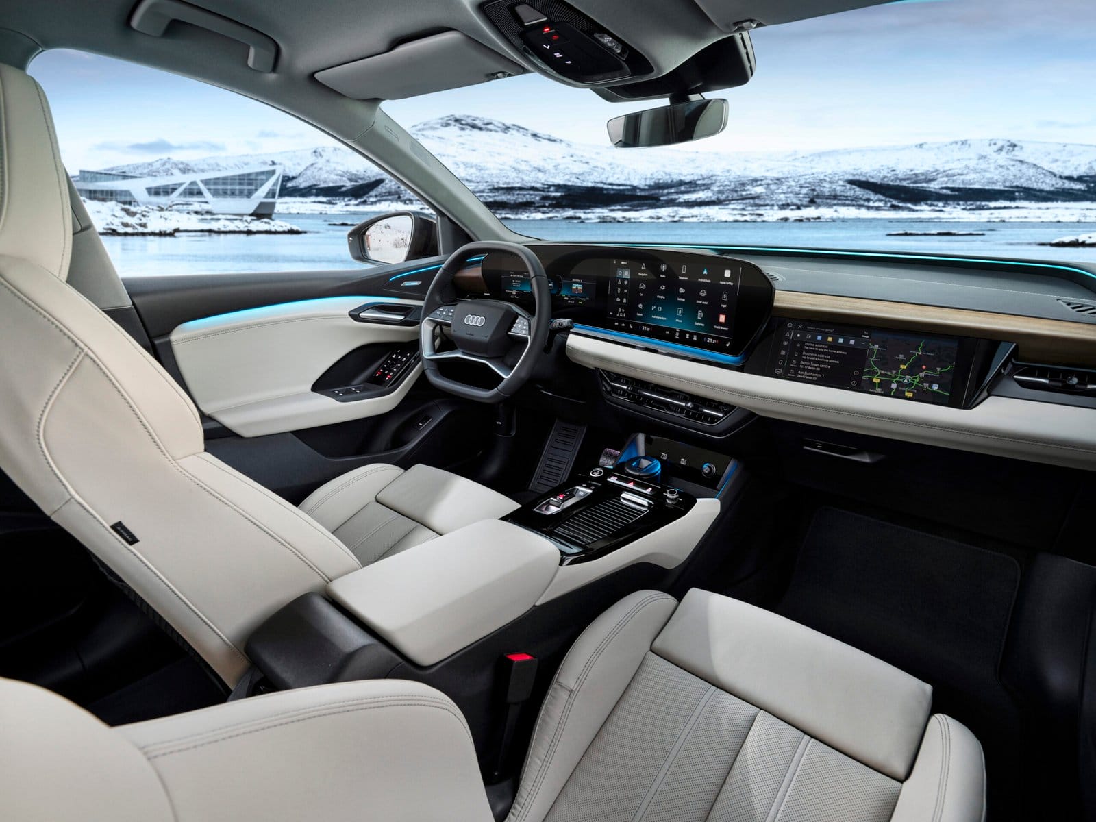 Audi Q6 electric vehicle cockpit showing three digital displays and modern interior