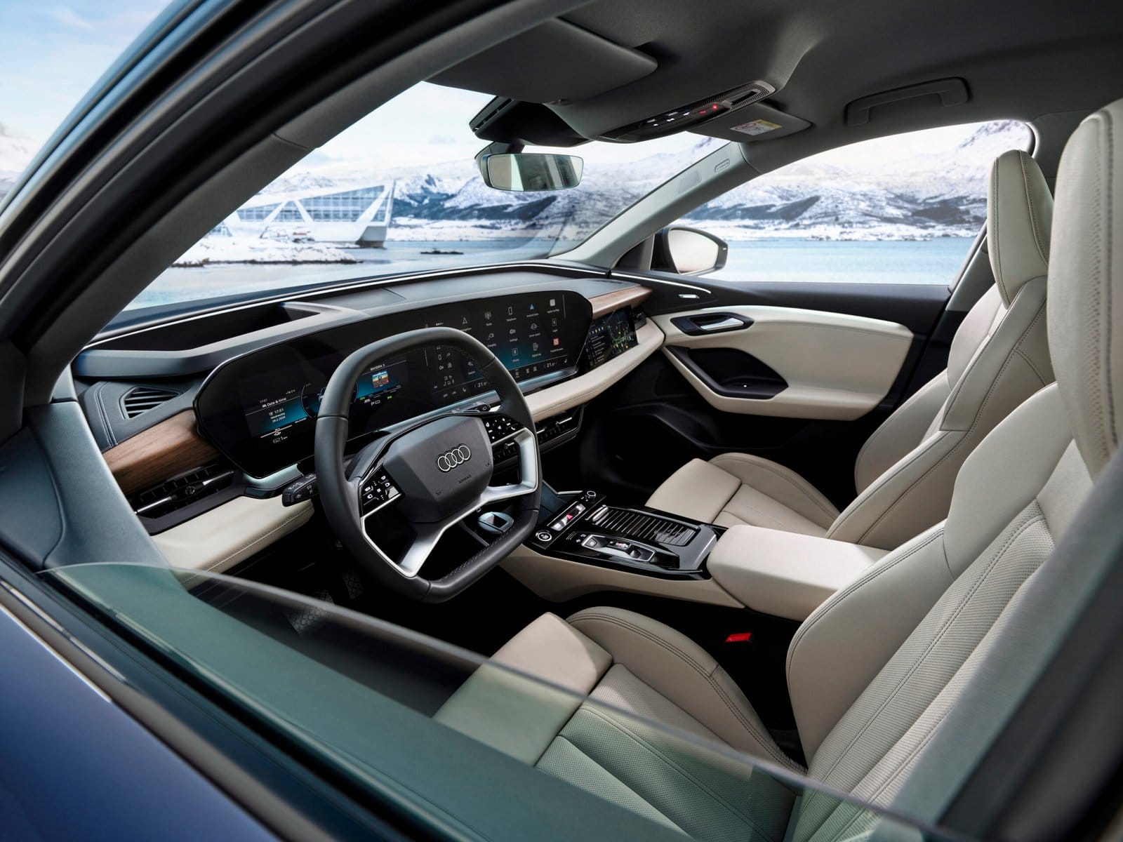 Interior of Audi Q6 electric vehicle showing dashboard, screens, and front seats