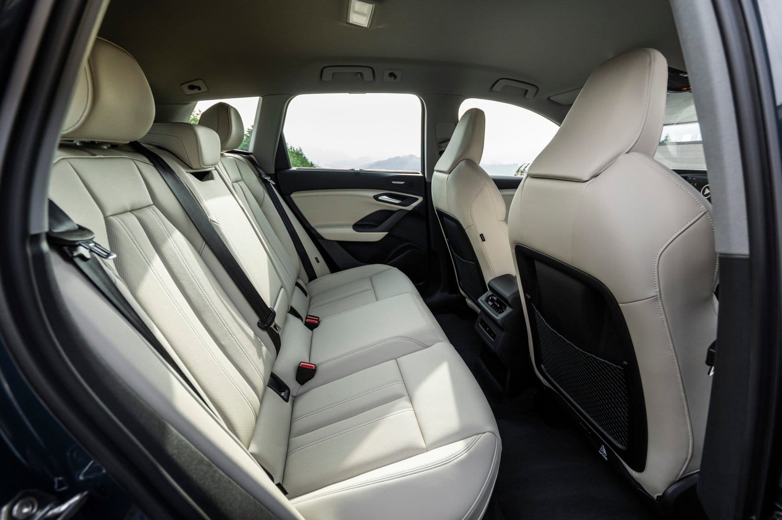 Rear seats of Audi Q6 electric vehicle showing spacious legroom and beige interior