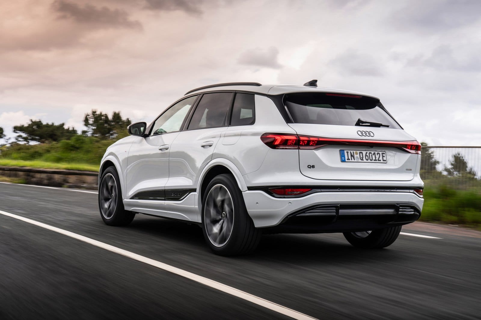 Rear three-quarter view of Audi Q6 electric vehicle driving on road