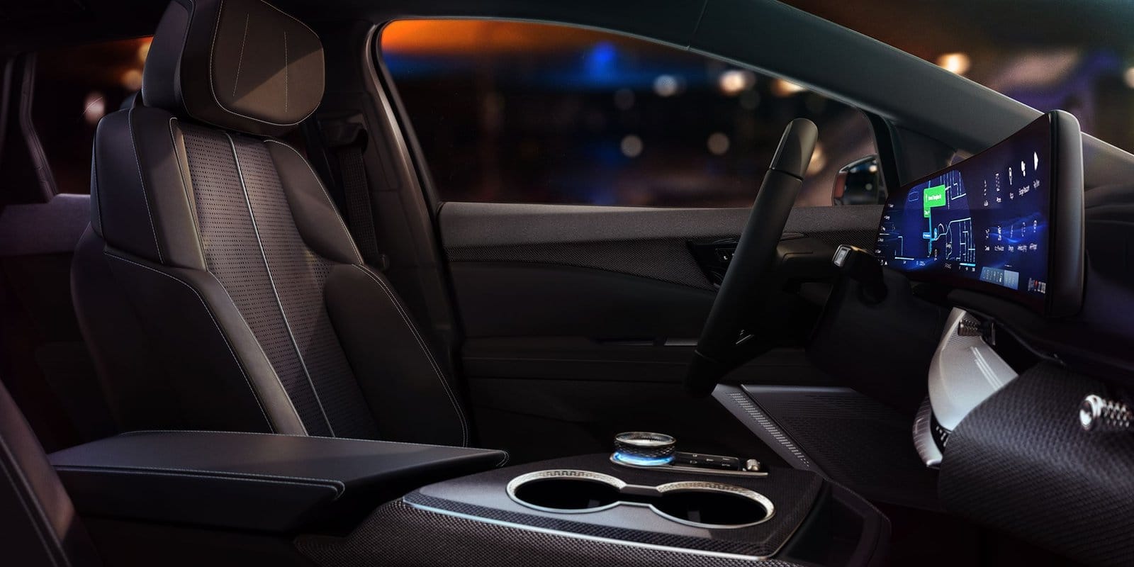 Perforated black leather driver’s seat and curved navigation display in the 2025 Cadillac Optiq electric vehicle