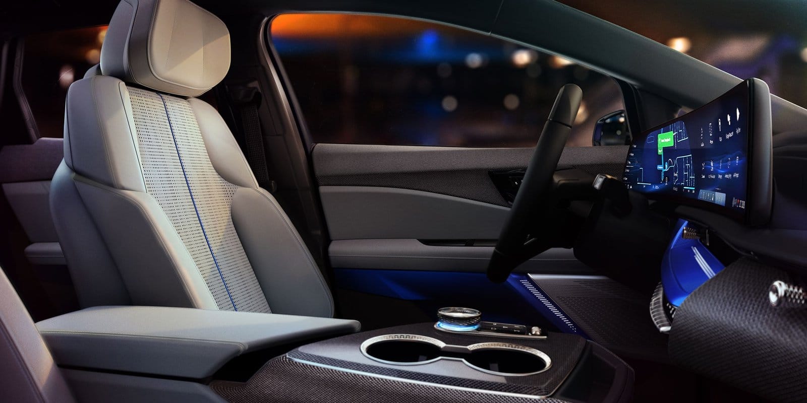 Light-colored front bucket seat of the 2025 Cadillac Optiq electric vehicle with perforated upholstery and ambient blue lighting