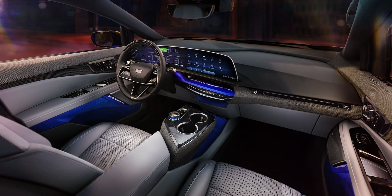 Modern front cabin view of the 2025 Cadillac Optiq electric vehicle featuring a full-width digital display and ambient lighting