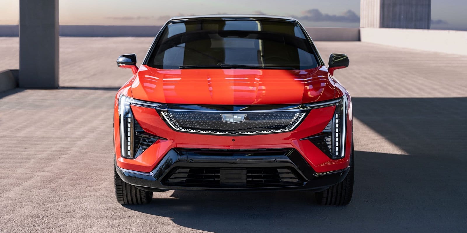 Direct front view of the Cadillac Optiq electric vehicle showing its grille, LED lights, and sleek design