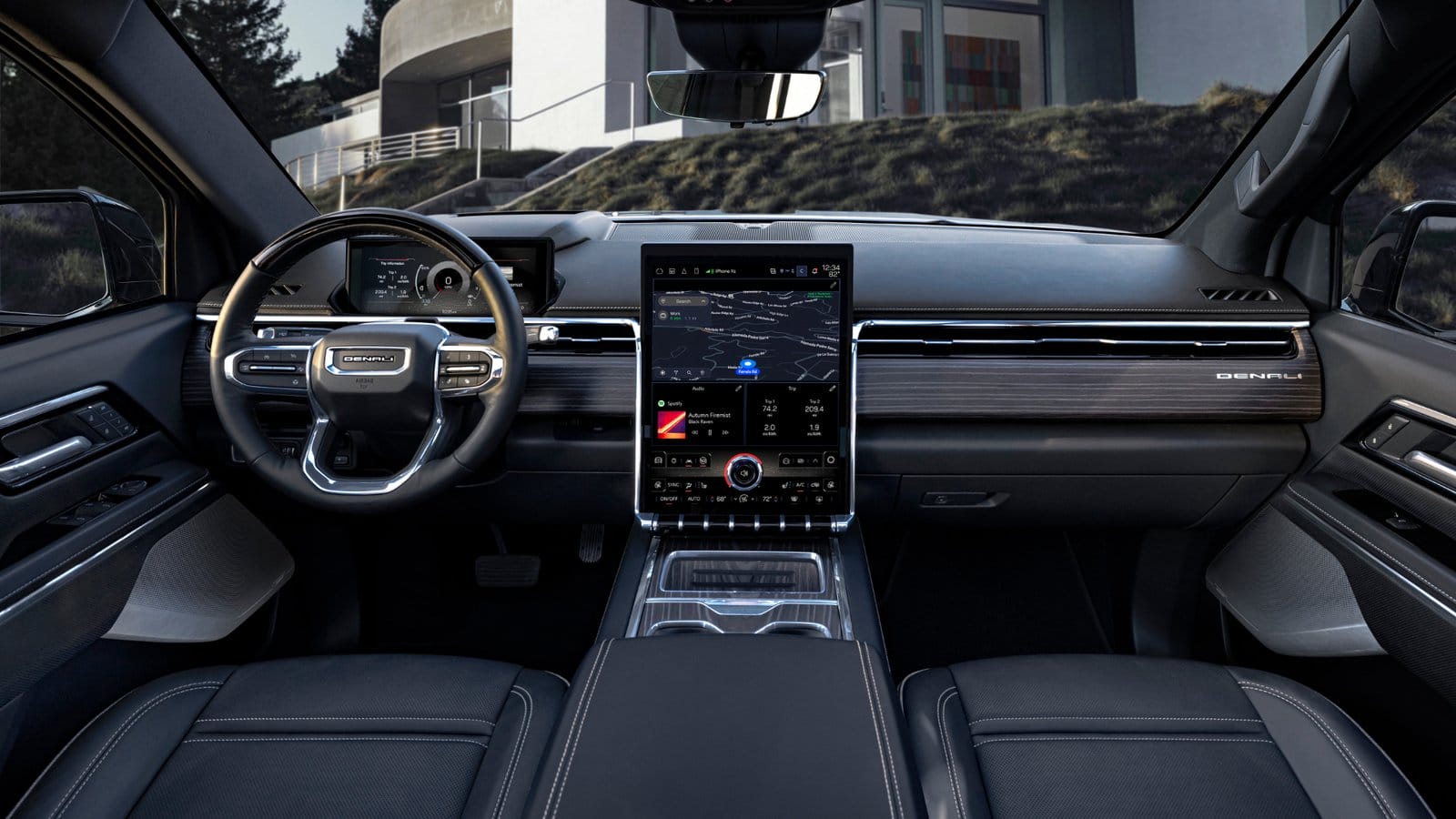Interior view of the GMC Sierra EV Denali electric vehicle showing the digital dashboard and large central infotainment touchscreen