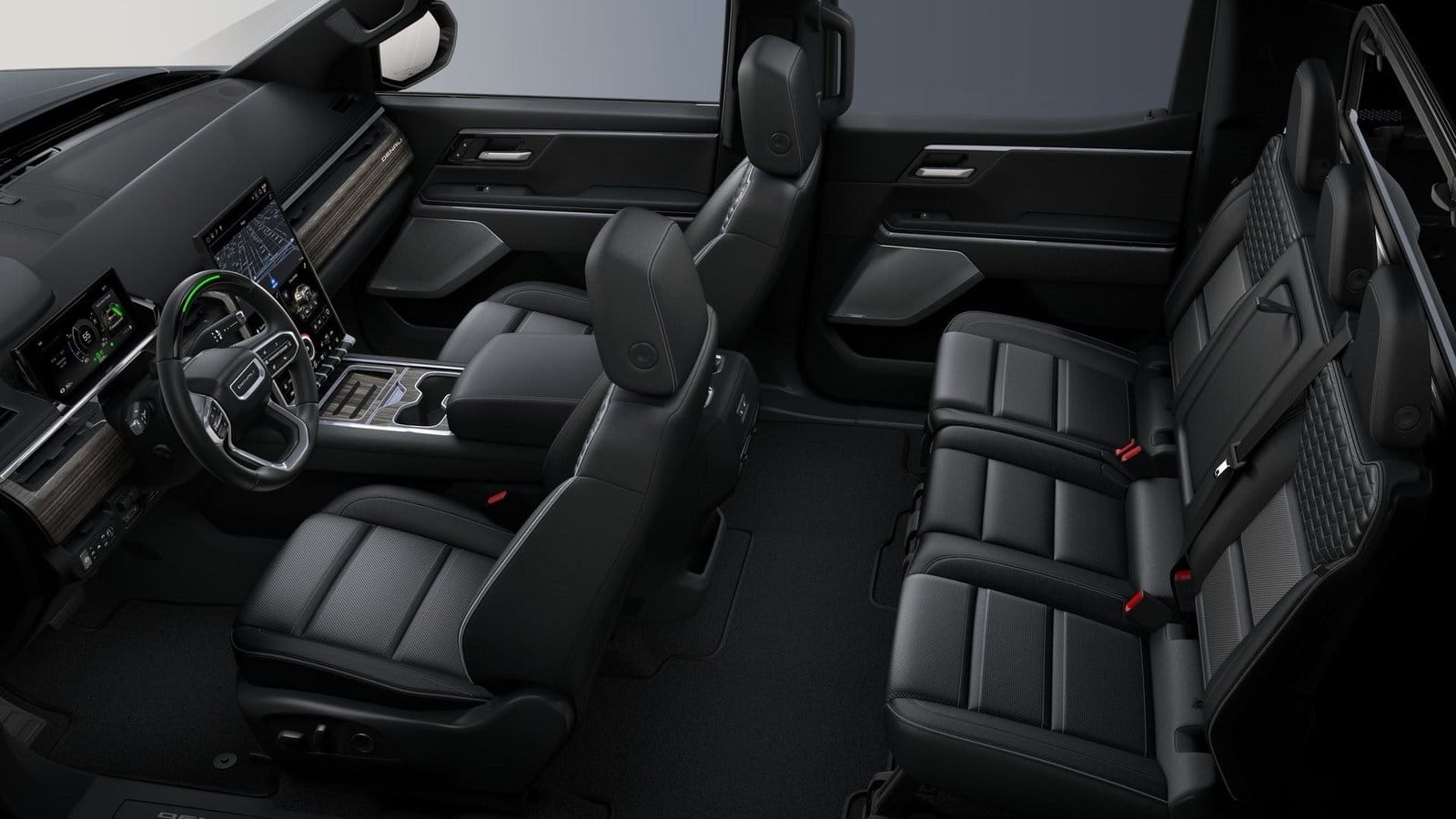 Overhead view of GMC Sierra EV Denali electric vehicle interior showing front and rear black leather seats, dashboard, and infotainment screens