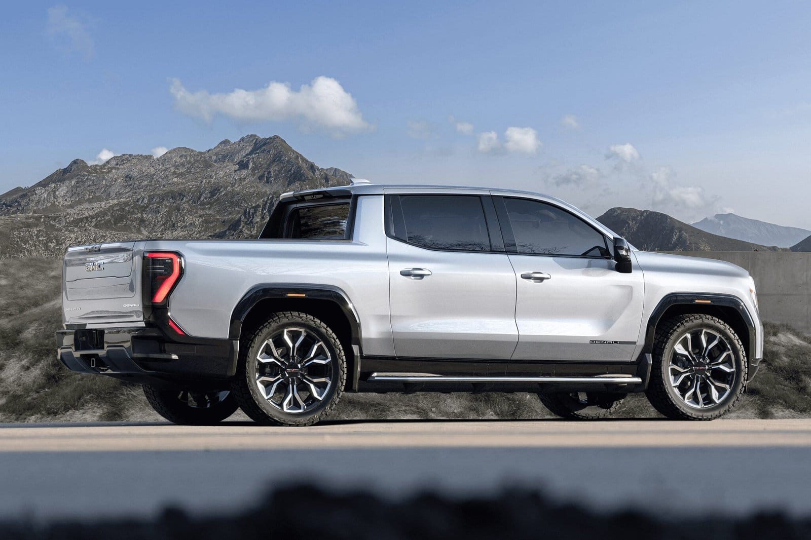 Side profile of GMC Sierra EV Denali electric vehicle parked on mountain road
