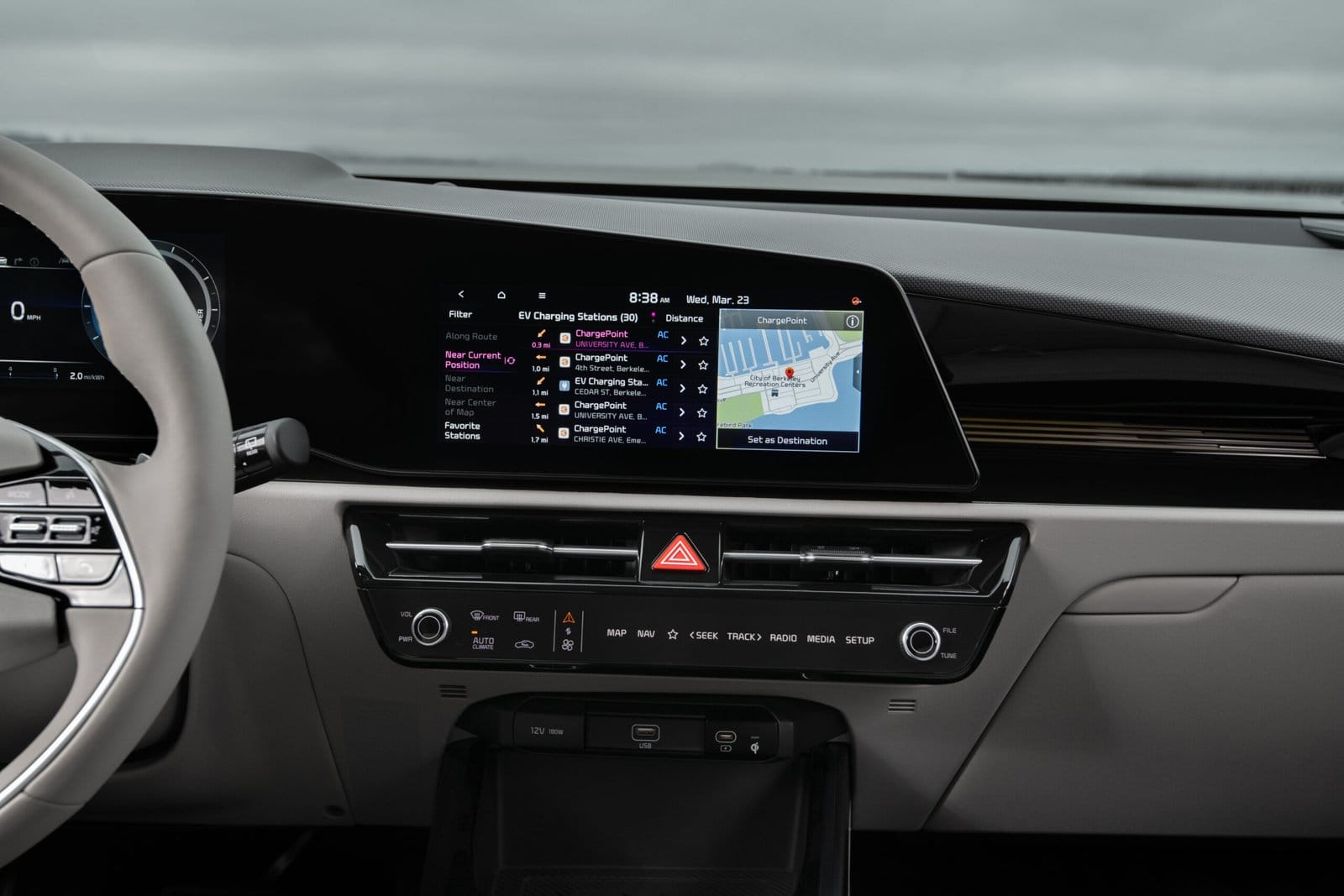 Infotainment screen of Kia Niro EV electric vehicle showing EV charging station locations and map navigation