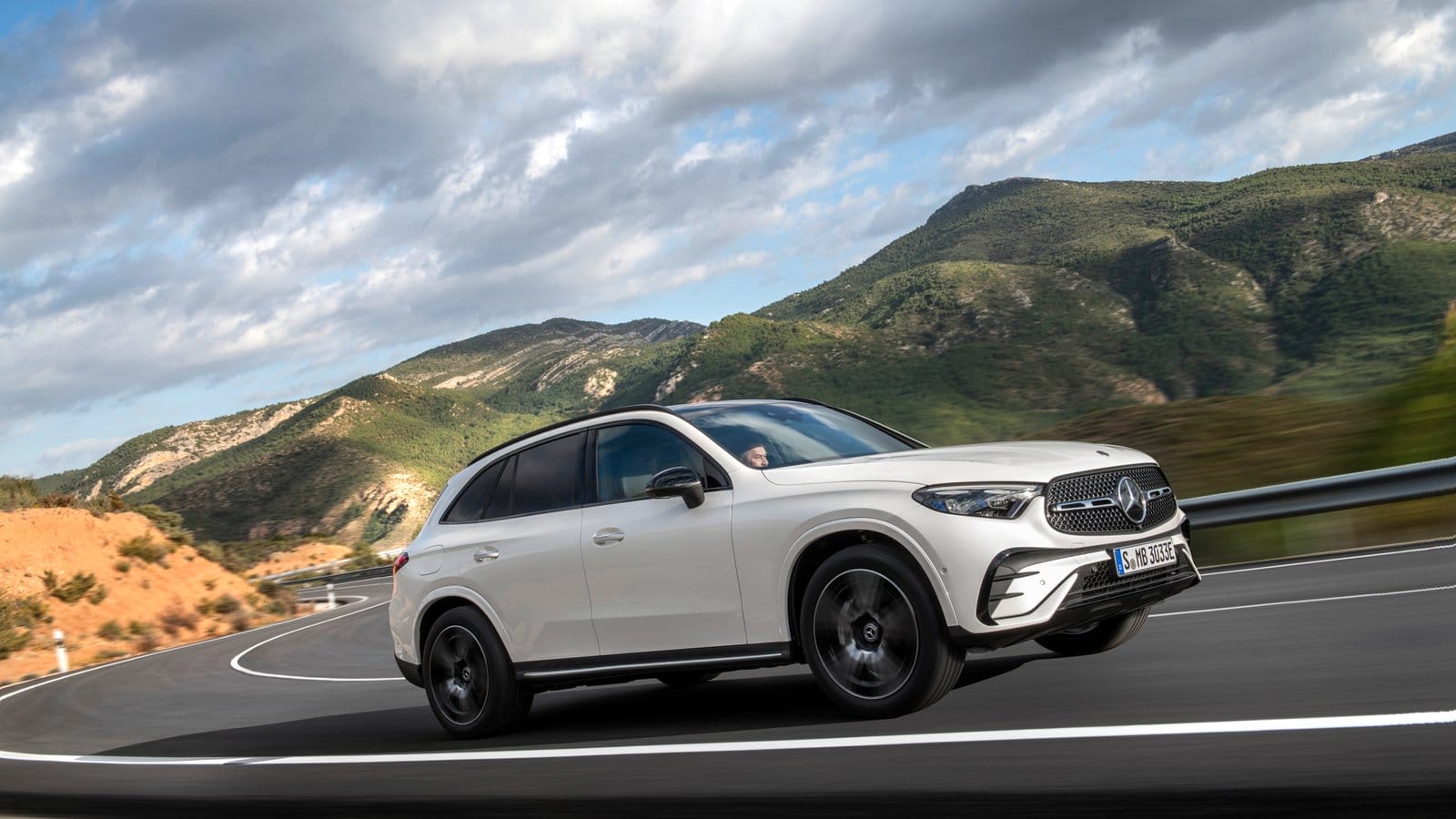 Mercedes-Benz GLC PHEV electric vehicle driving on a curved mountain road