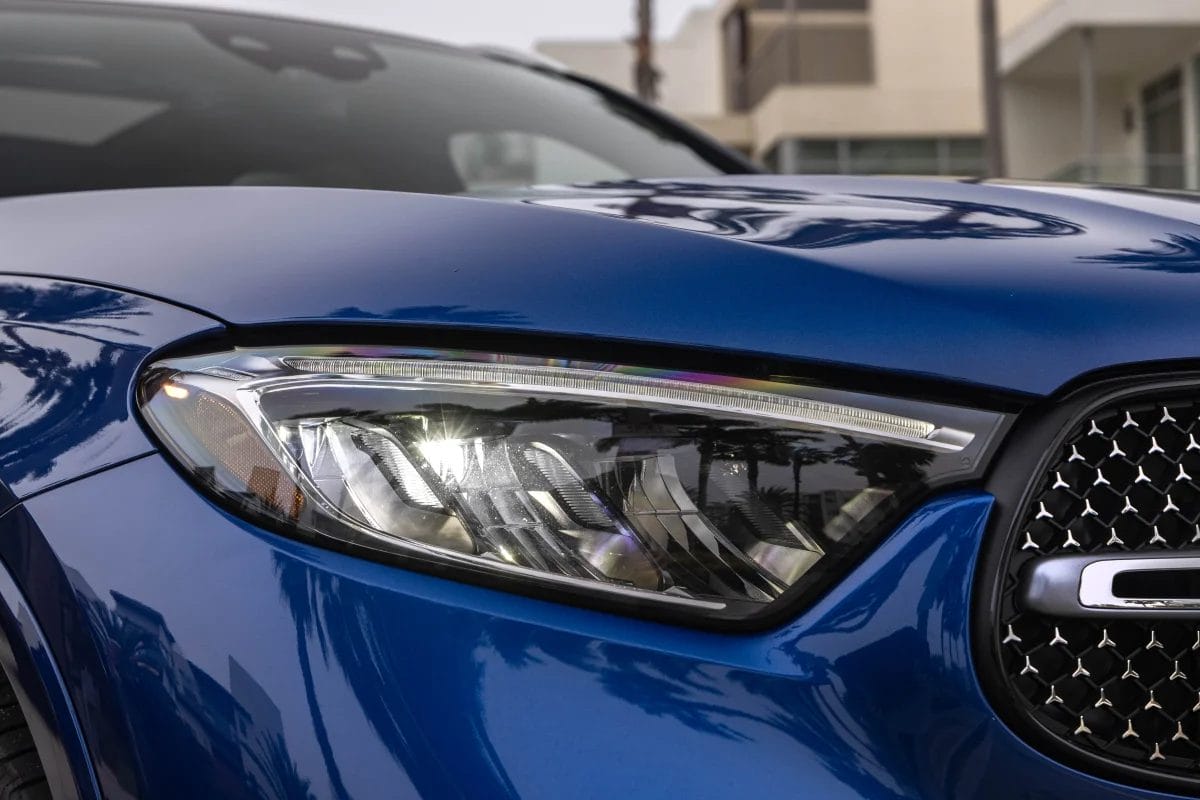 Close-up of the headlight on a blue Mercedes-Benz GLC PHEV electric vehicle