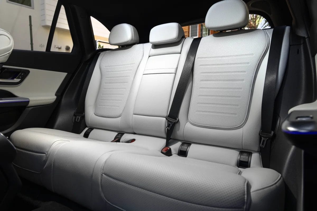Rear seat view of the Mercedes-Benz GLC PHEV electric vehicle with light-colored upholstery and three headrests
