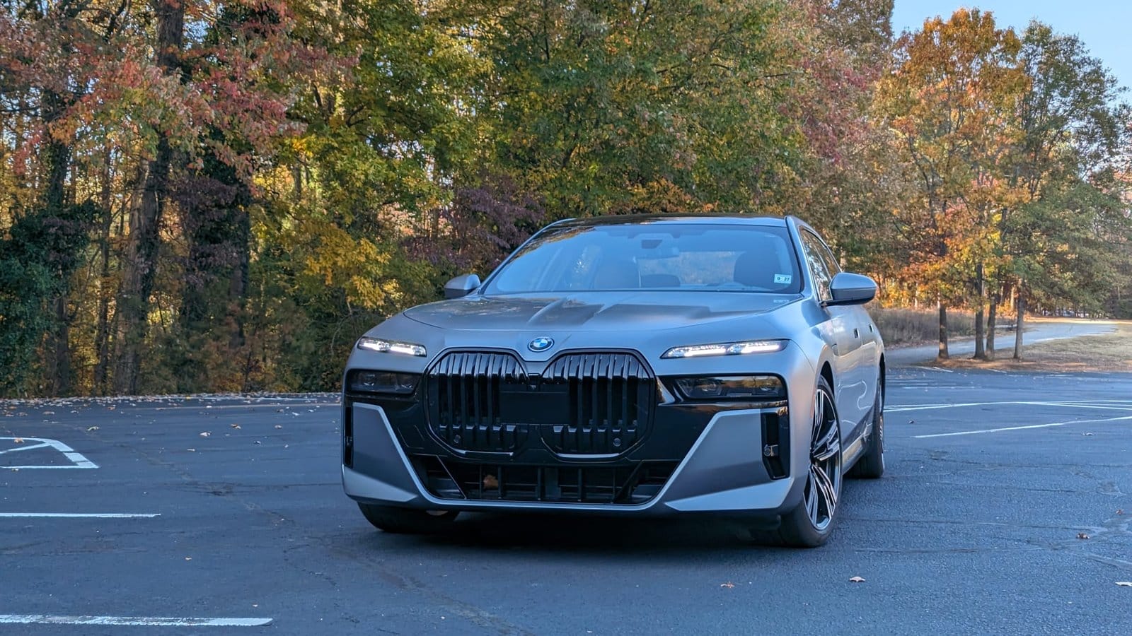 BMW 750e xDrive electric vehicle front view with signature kidney grilles and slim LED lights in a matte silver finish