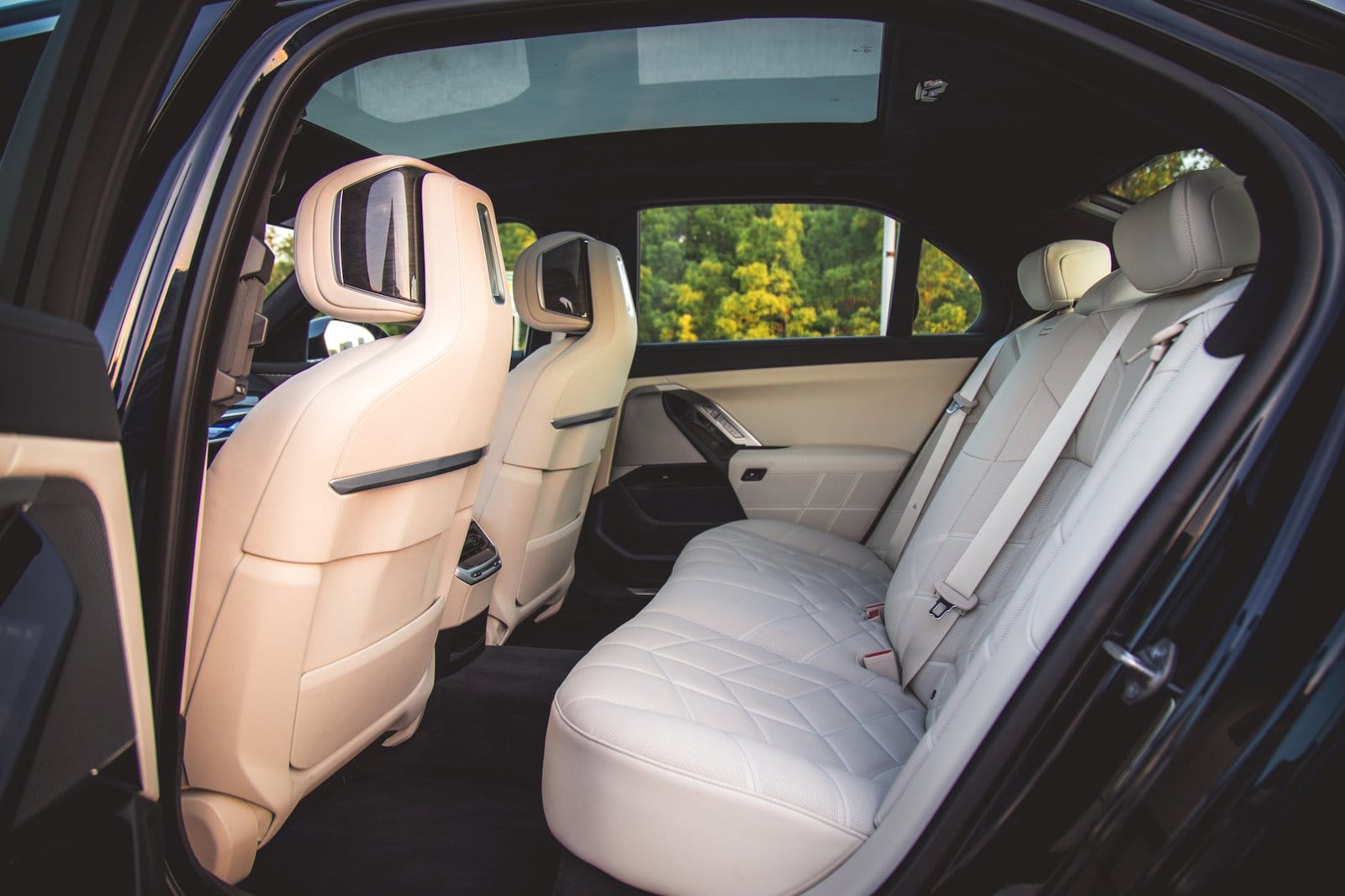 Rear white leather seating of BMW 750e xDrive Plug-in Hybrid viewed from rear passenger door