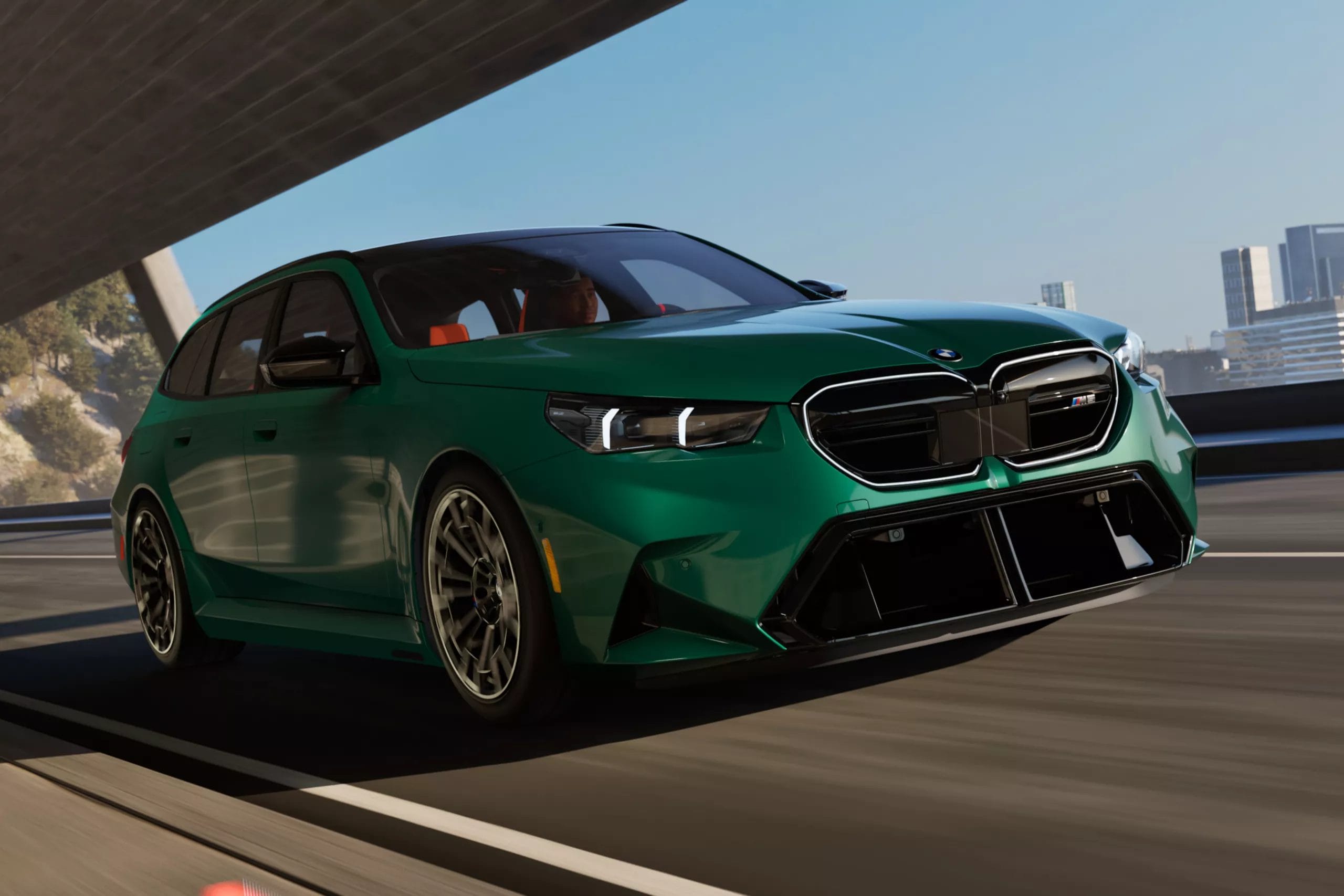 Green BMW M5 Touring Plug-in Hybrid driving under bridge on city highway