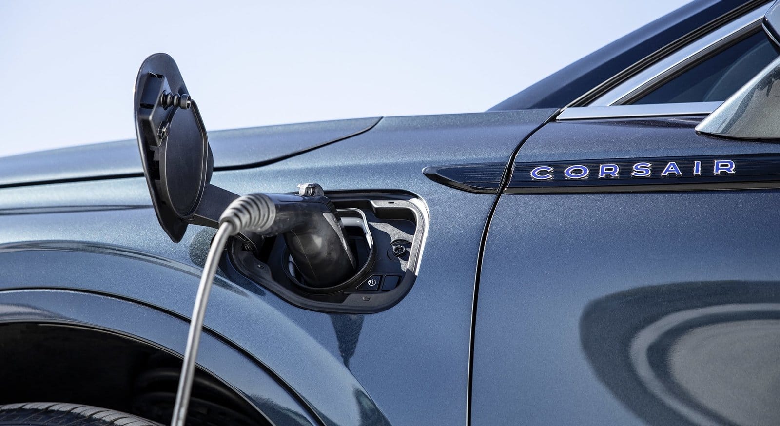 Lincoln Corsair electric vehicle with charging cable plugged into front side charging port