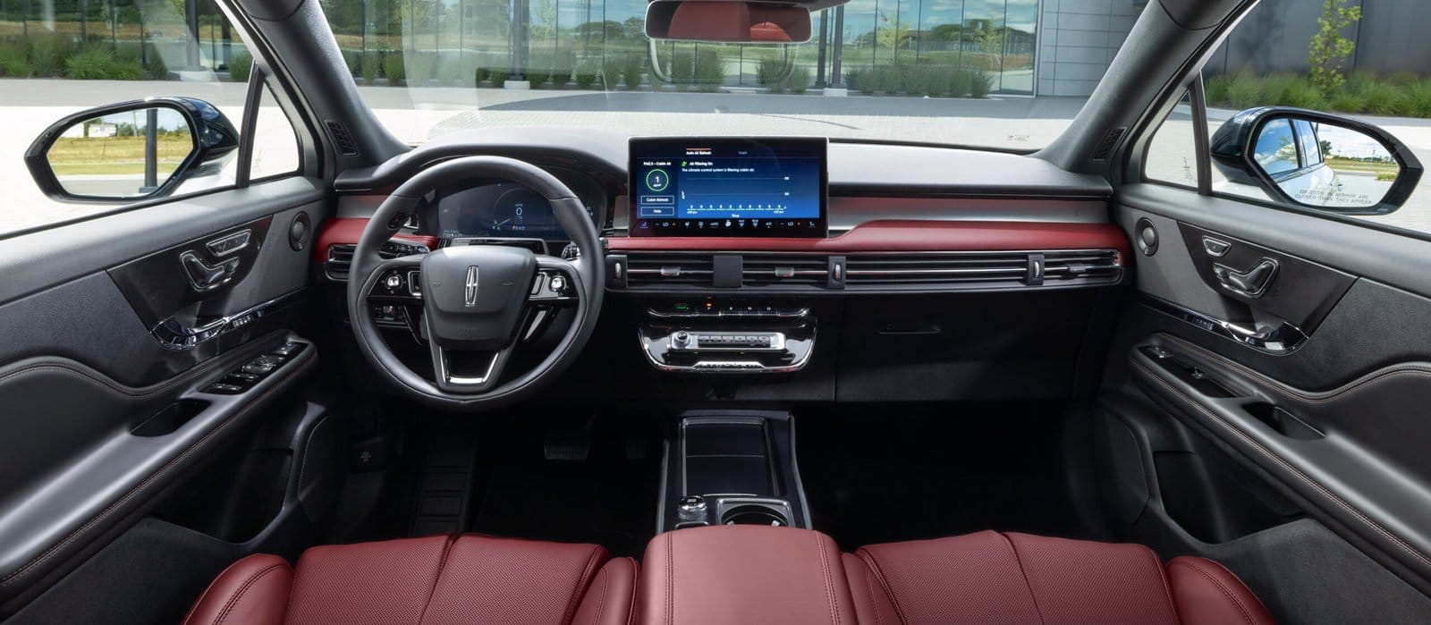Front view of 2025 Lincoln Corsair electric vehicle interior showing Eternal Red dashboard and steering wheel