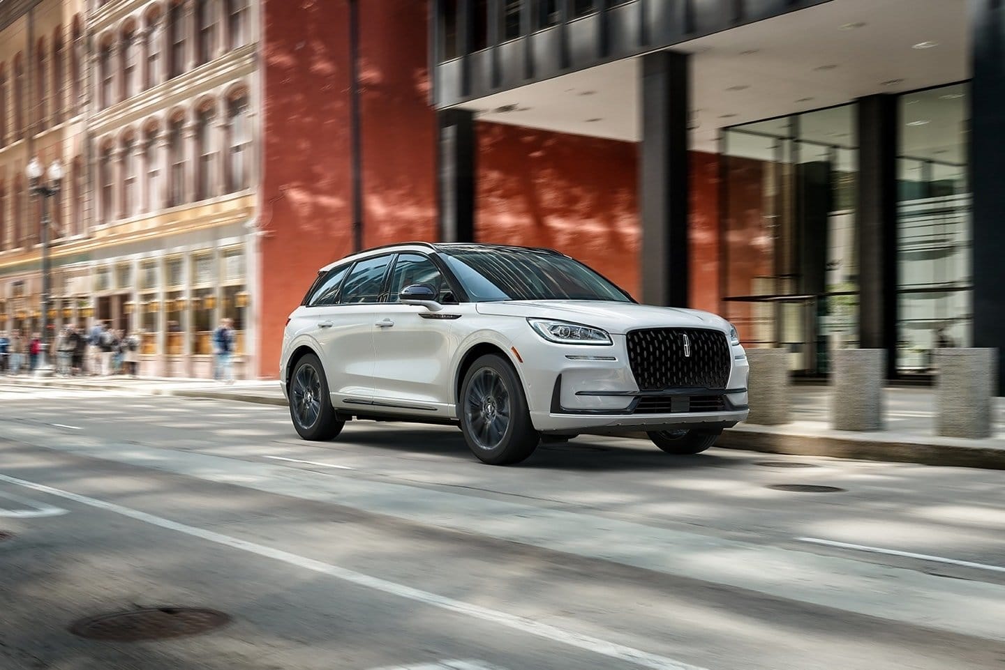 Front-side view of Lincoln Corsair Grand Touring plug-in hybrid driving on a city street