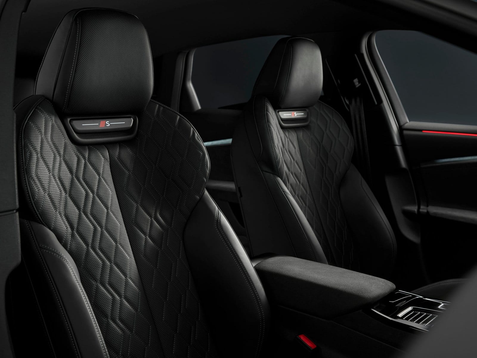 Front seats of Audi S6 e-tron electric vehicle with quilted leather upholstery and integrated headrest logos.
