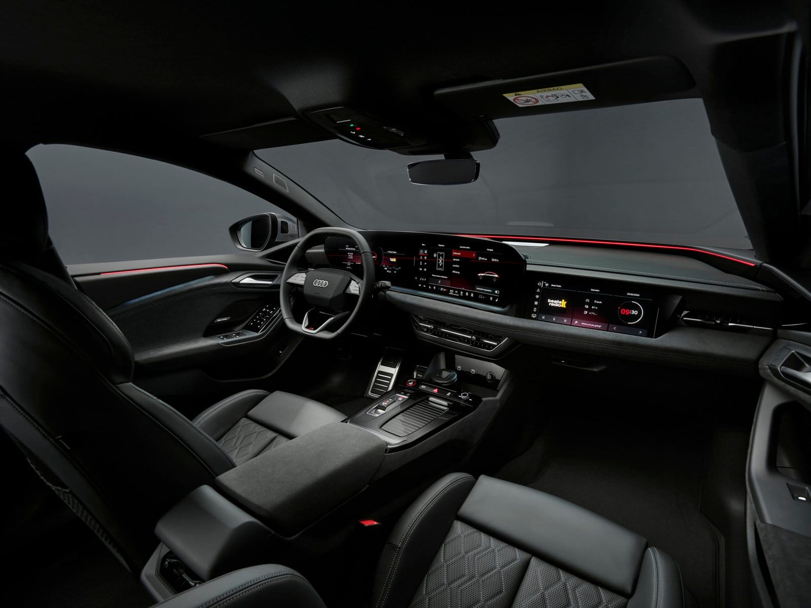 Interior view of Audi S6 e-tron electric vehicle showing dashboard, steering wheel, and digital displays.