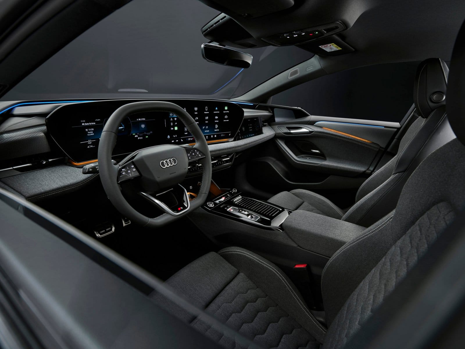 Dashboard and steering wheel view of the 2025 Audi A6 e-tron electric vehicle with dual digital displays