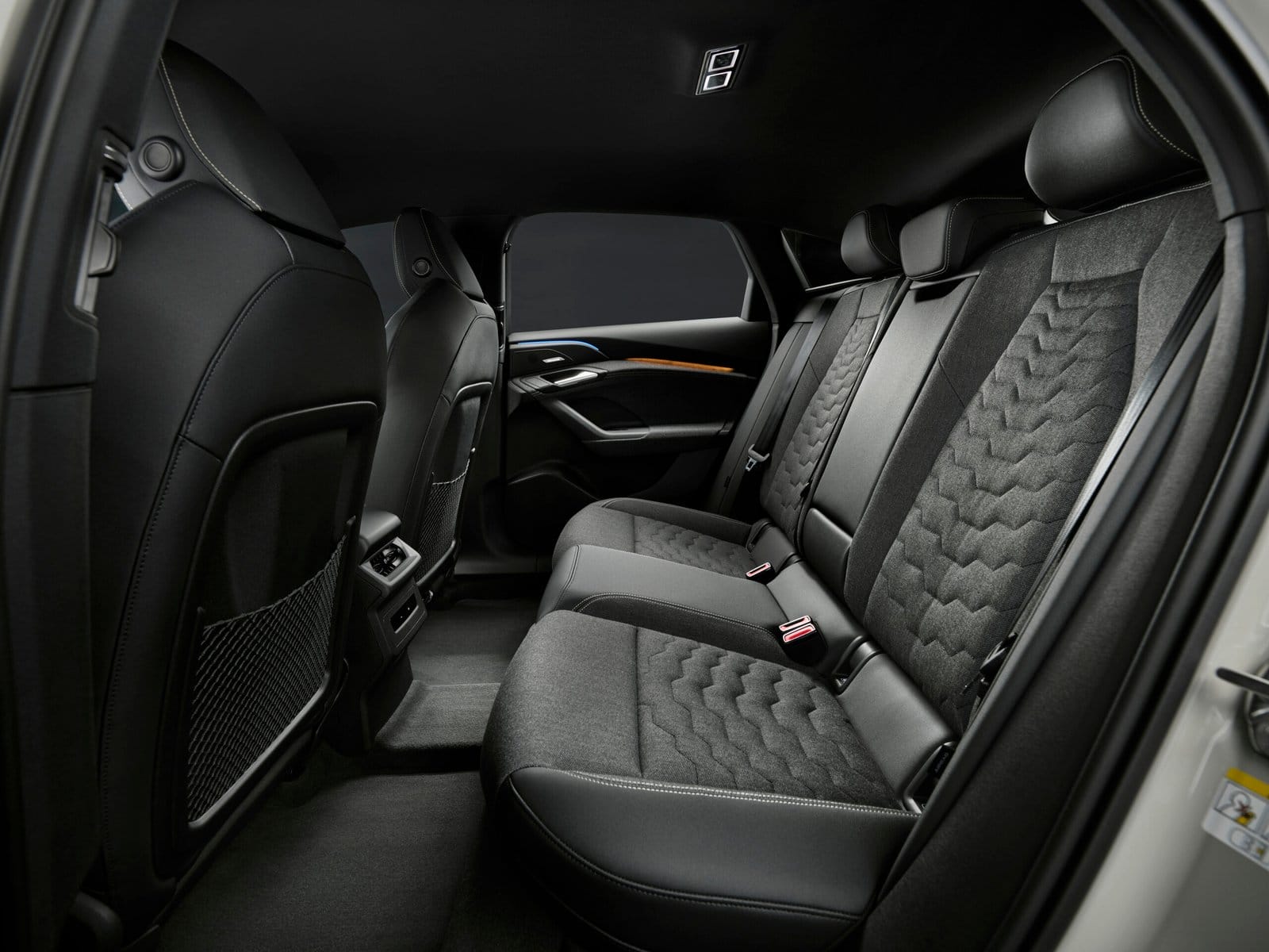 Rear seat interior of the 2025 Audi A6 e-tron electric vehicle showing fabric upholstery and legroom