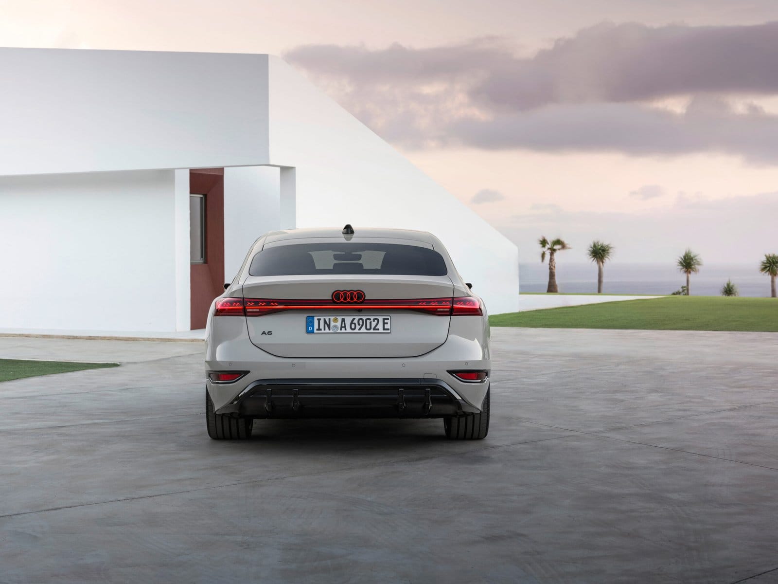 Rear exterior view of the 2025 Audi A6 e-tron electric vehicle with LED taillights illuminated