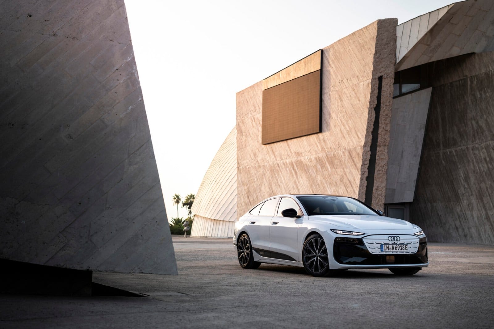 2025 Audi A6 e-tron electric vehicle parked near modern architectural buildings