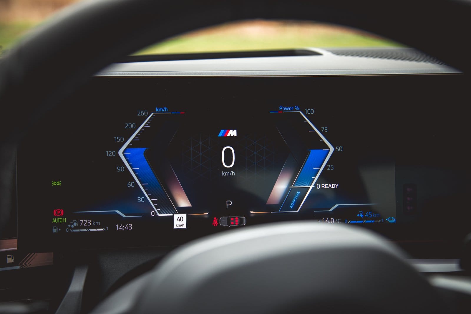 Close-up of BMW 550e xDrive electric vehicle digital instrument cluster showing speedometer and power gauge