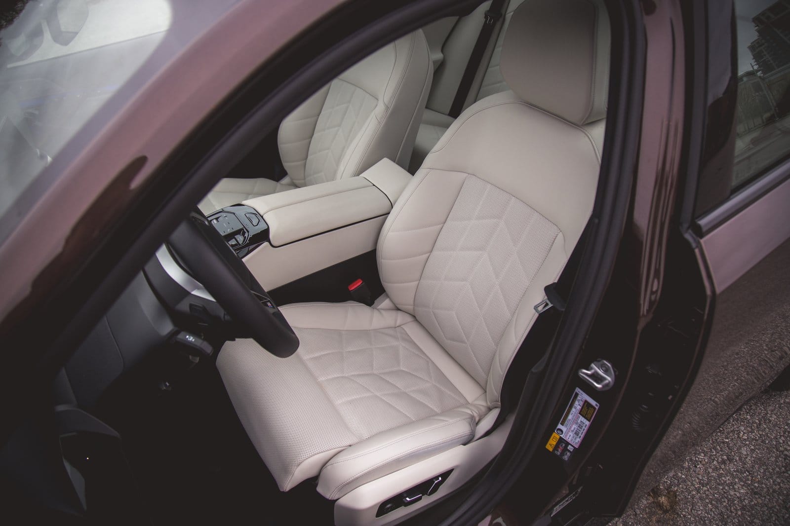 Close-up of BMW 550e xDrive electric vehicle front seat with quilted upholstery