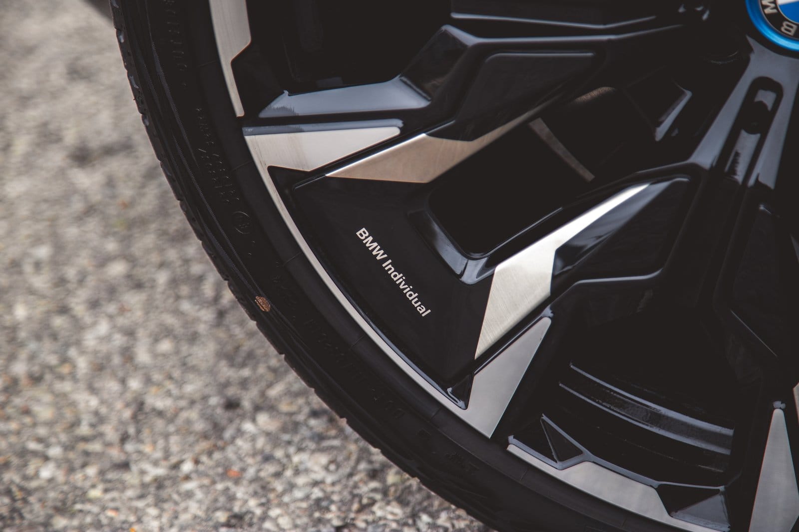 Close-up of BMW 550e xDrive electric vehicle alloy wheel showing BMW Individual detail